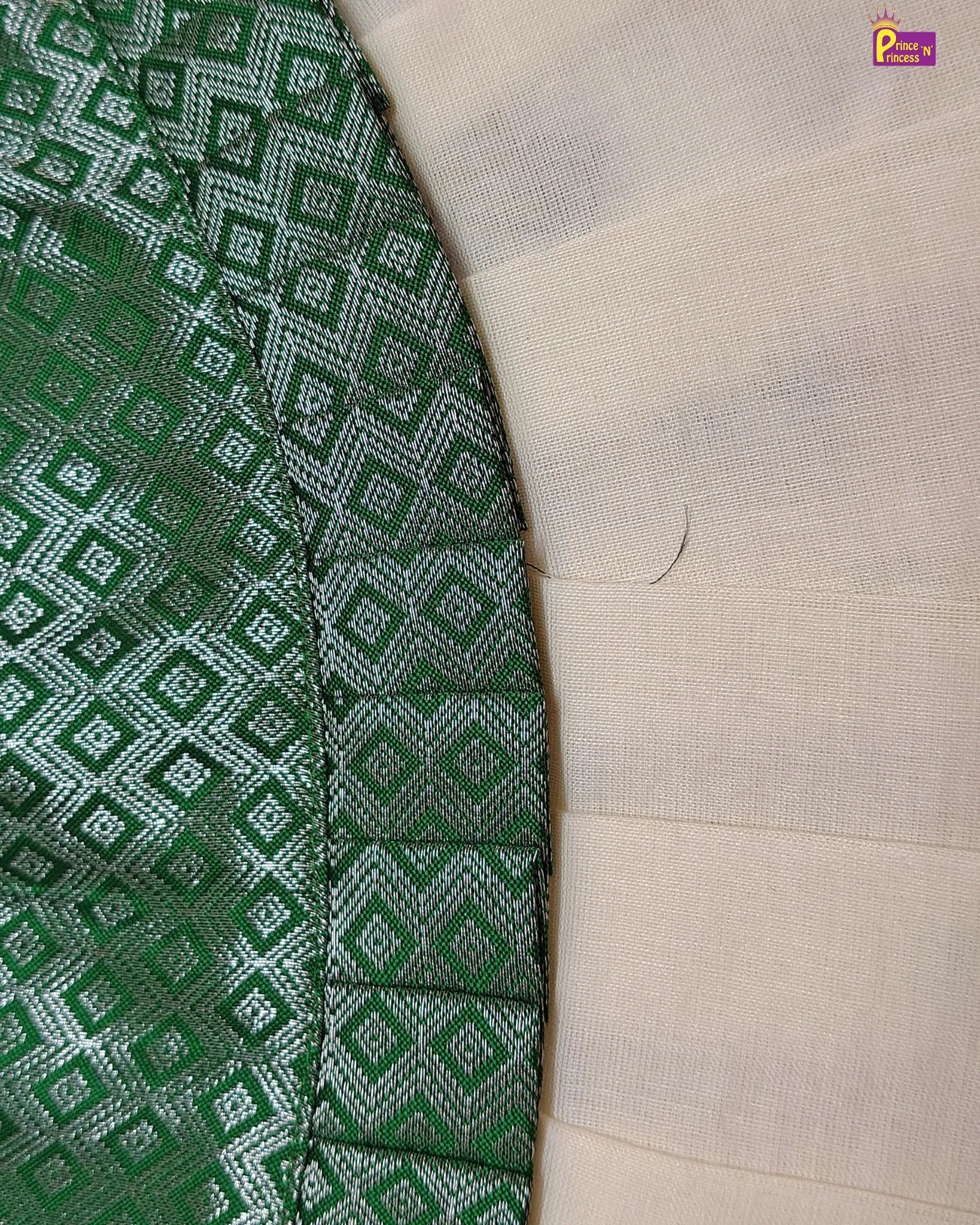 Close-up of green and white patterned fabric with a beige background