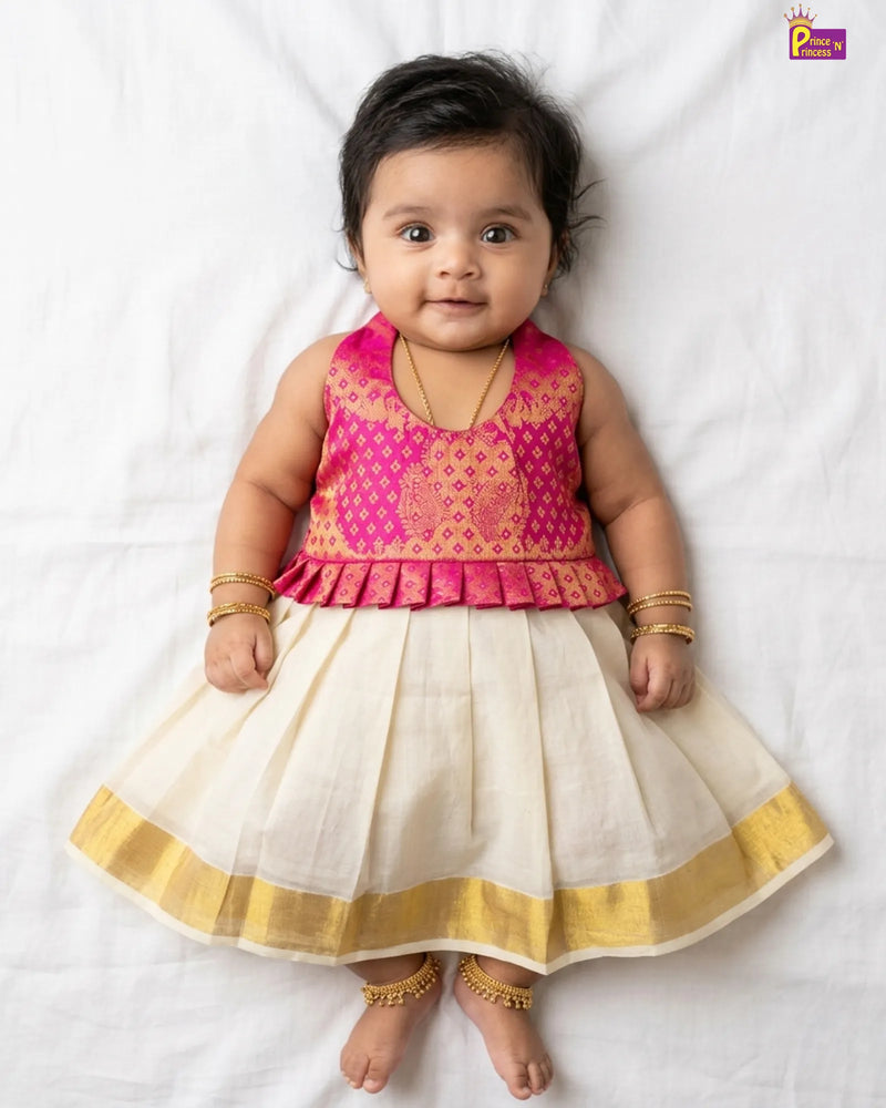 Baby wearing a pink and white traditional outfit on a white background