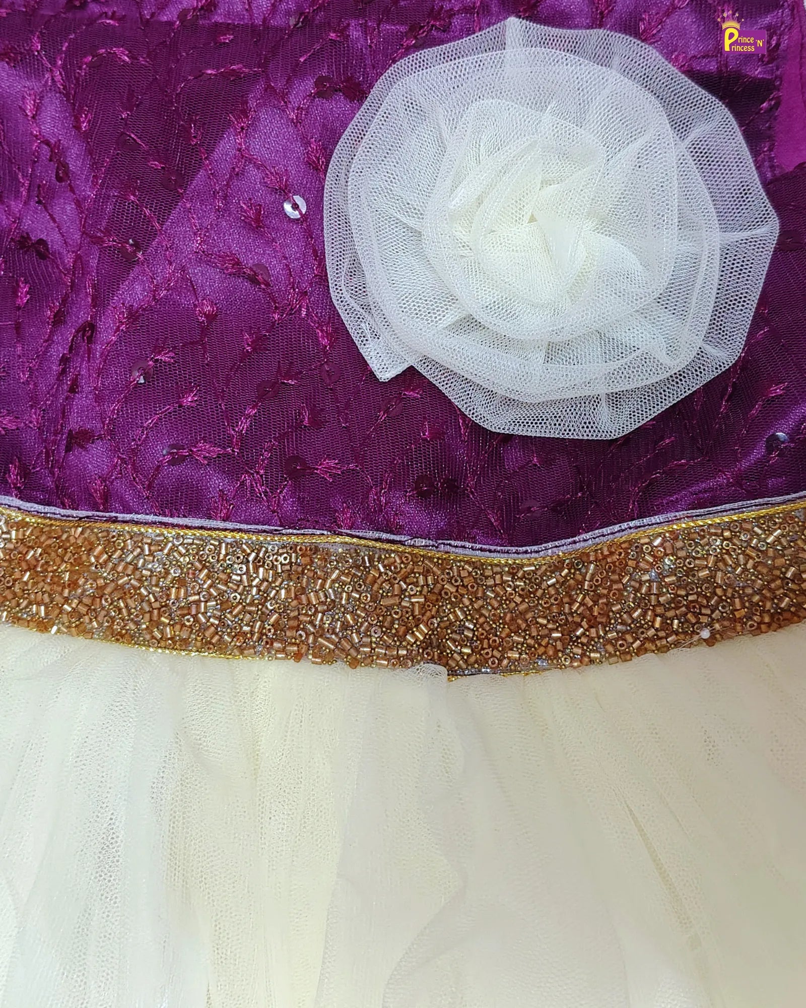 Purple fabric with a white flower and gold border