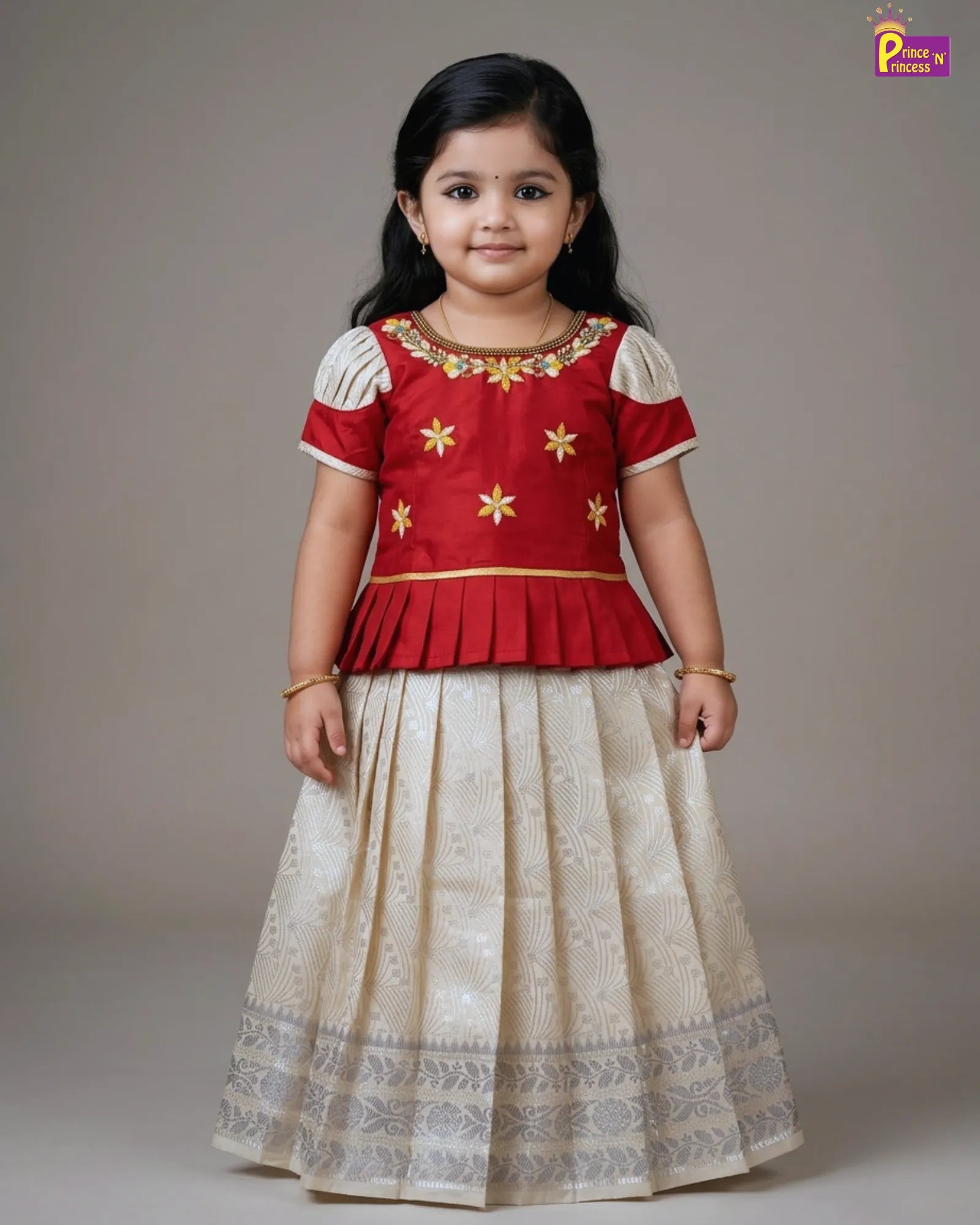 Young girl wearing a red and white traditional outfit with gold details on a plain background