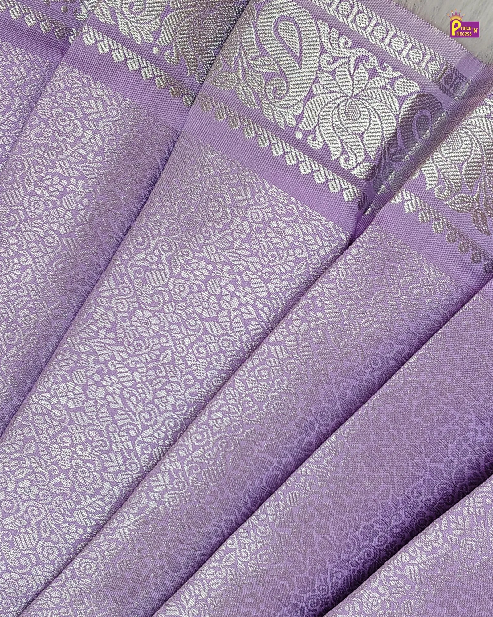 Purple fabric with white floral patterns, displayed in a folded manner.