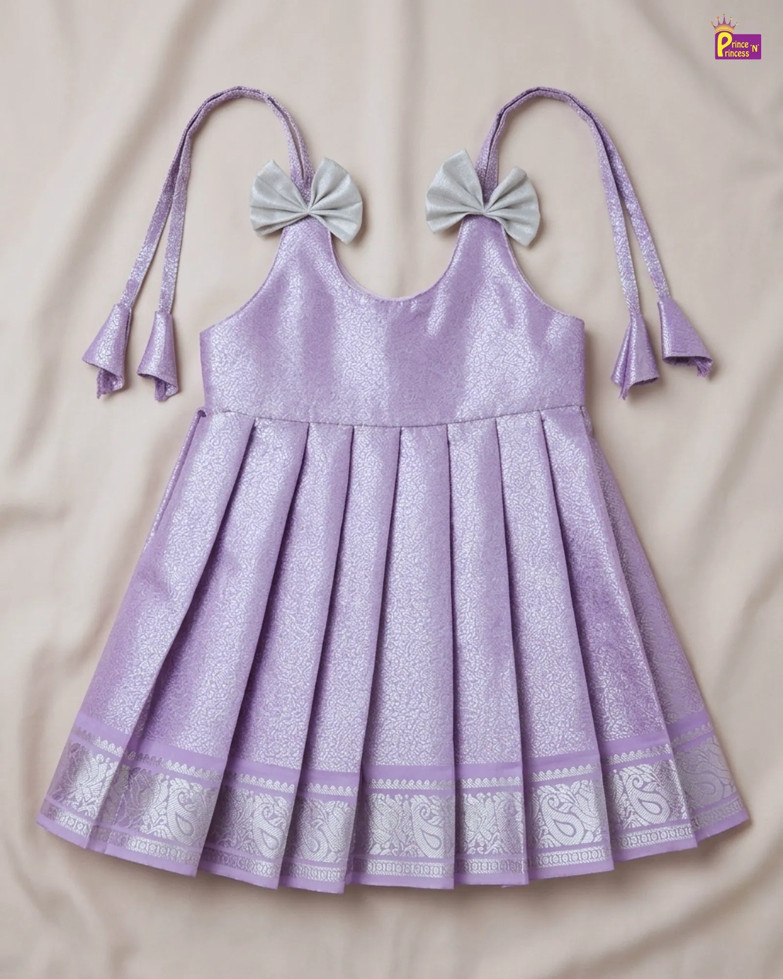 Purple dress with decorative bows on a beige background