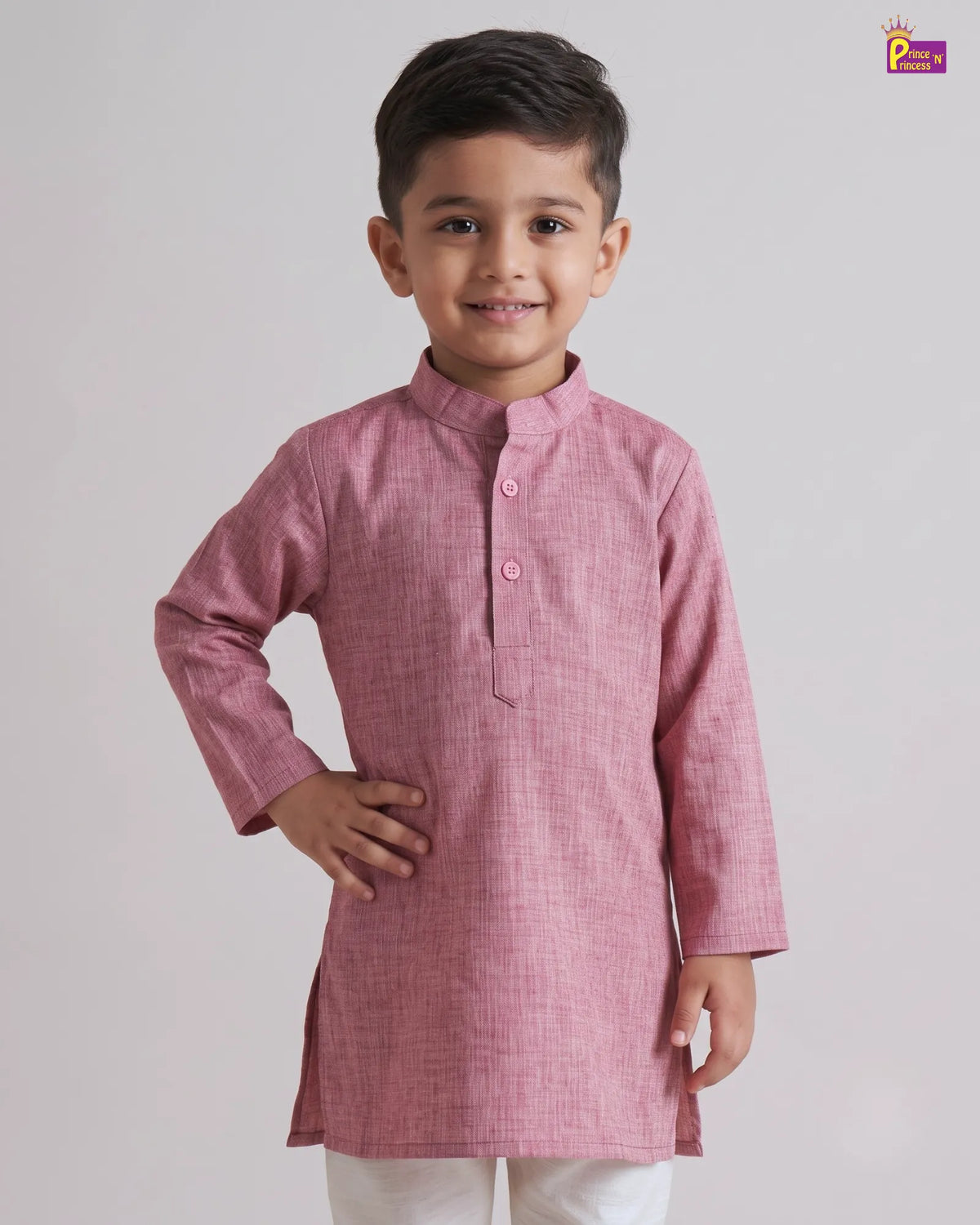A young boy modeling a pink long-sleeve kurta with a mandarin collar and three-button placket, paired with white trousers, against a light gray studio background.