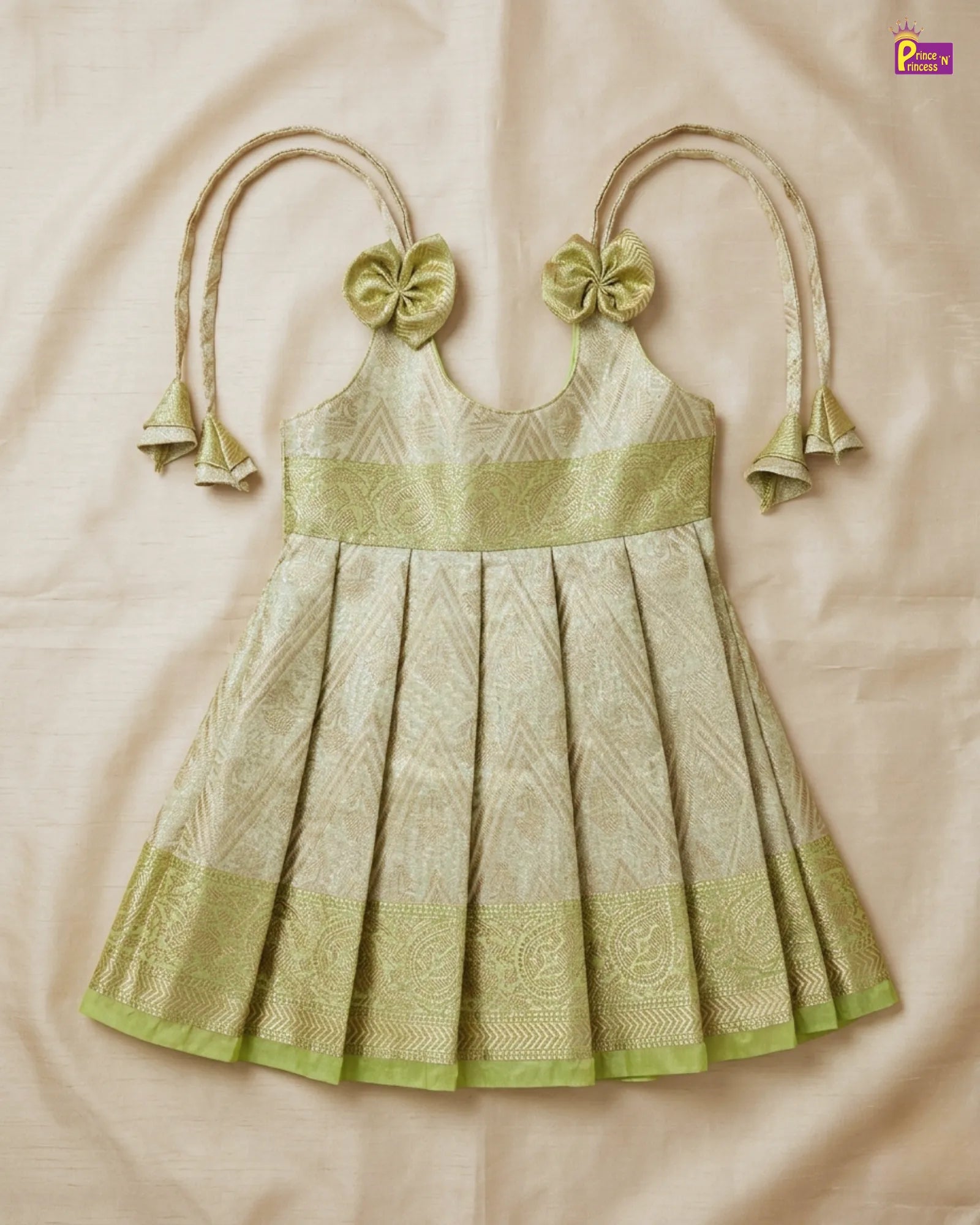 Green and beige dress with floral hair accessories on a beige background