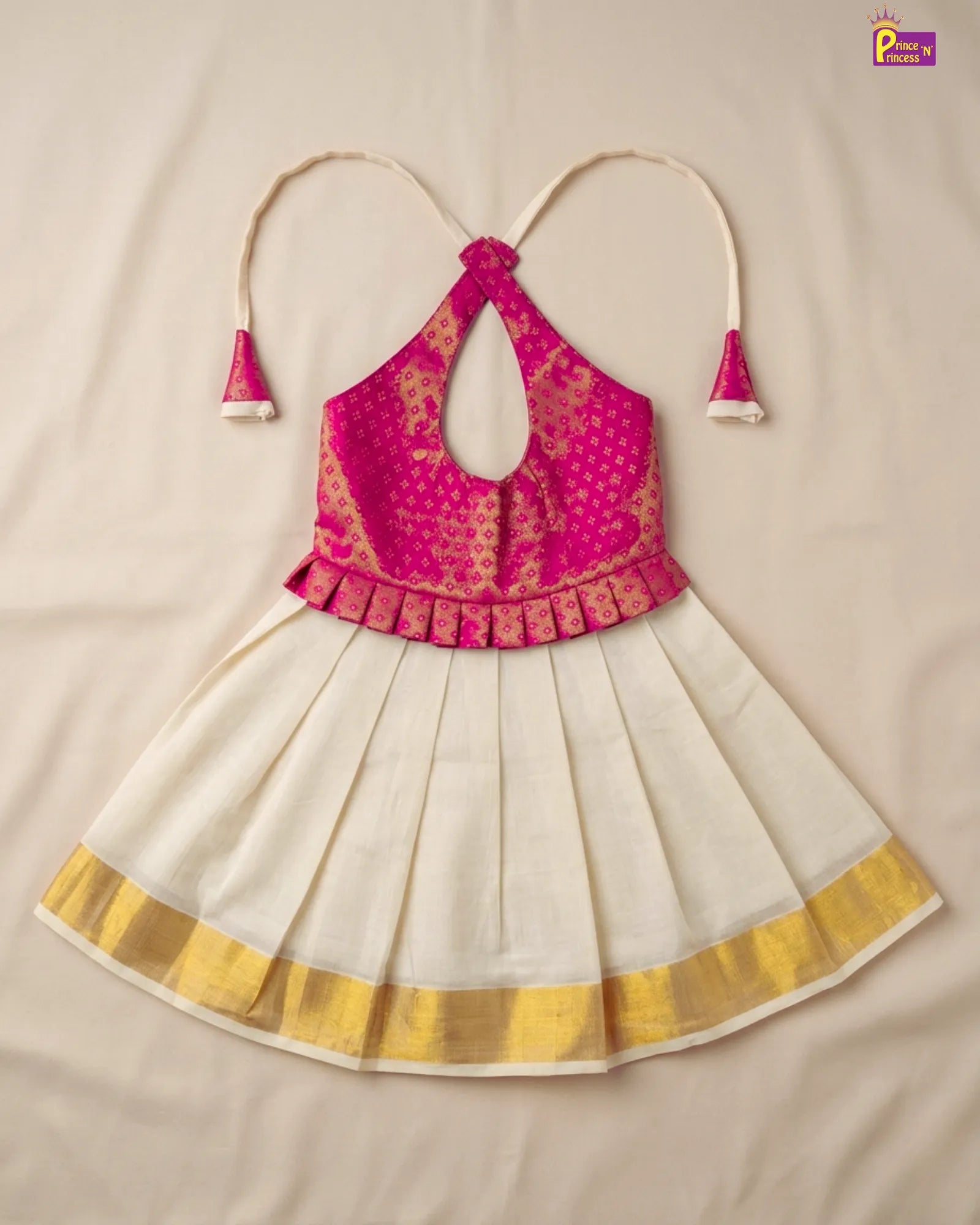 Pink and white traditional outfit with gold accents on a beige background