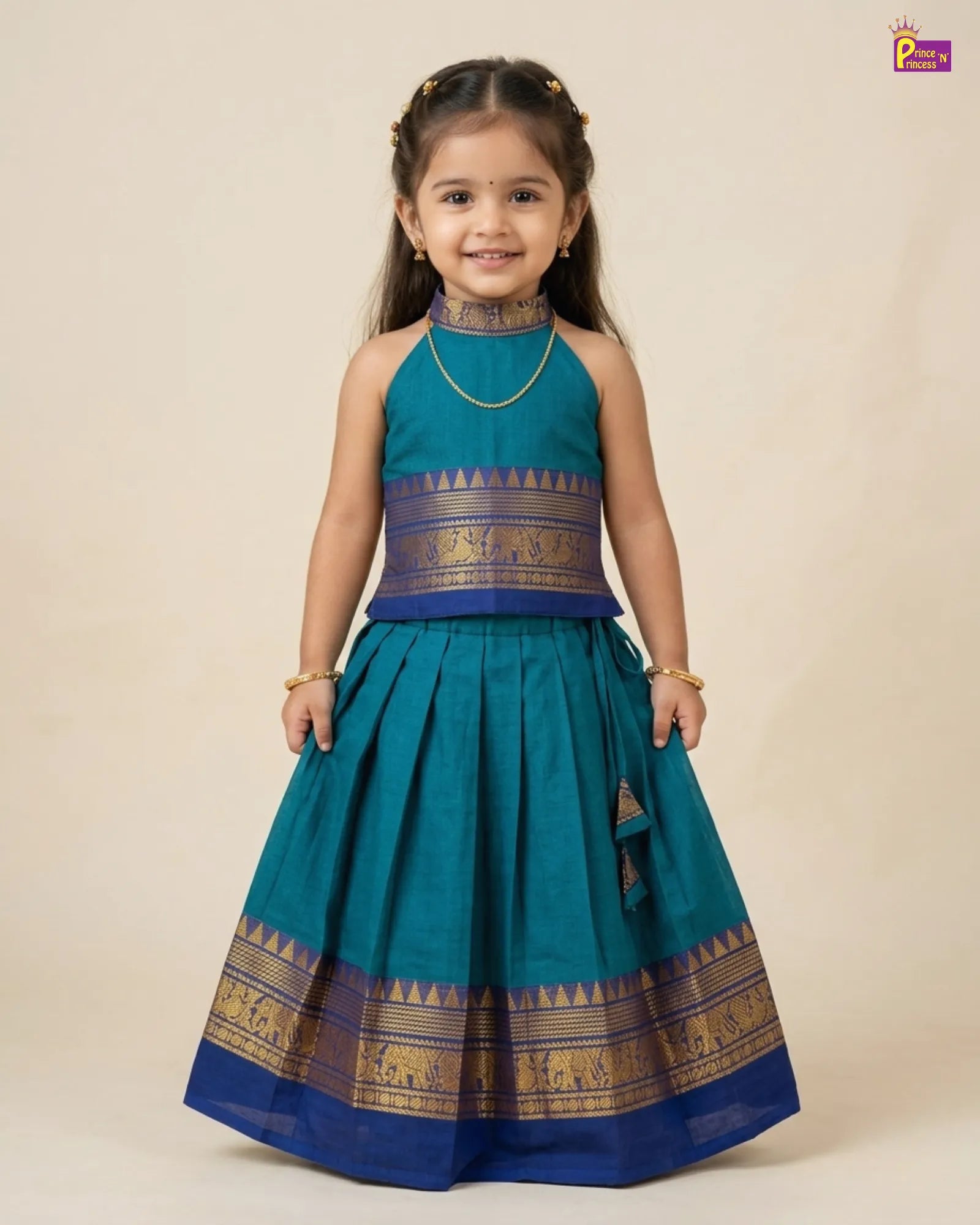 Young girl wearing a traditional teal and blue dress with gold accents on a beige background