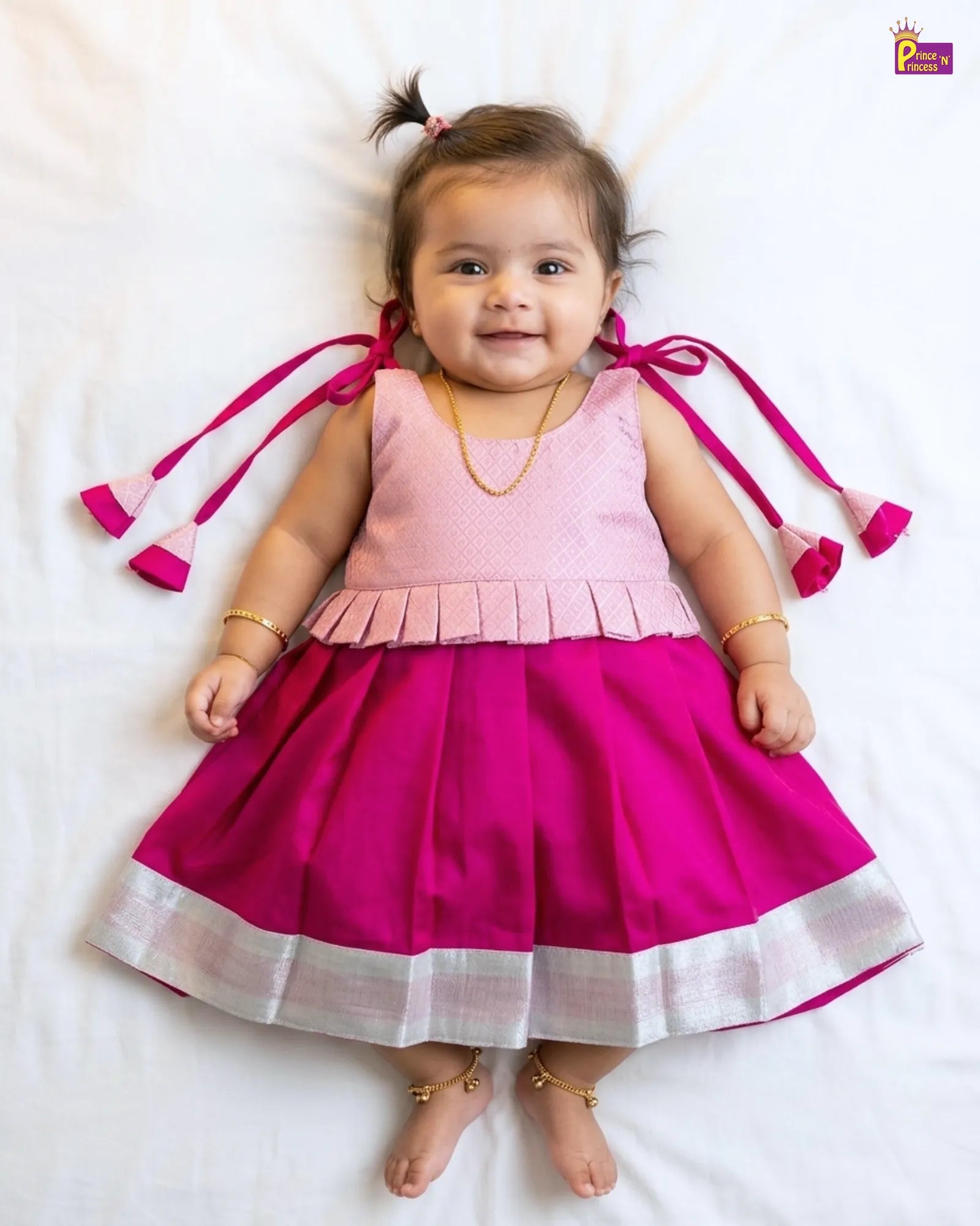 Newborn baby girl pink peplum pattu silk frock with a magenta pleated skirt and silver zari border