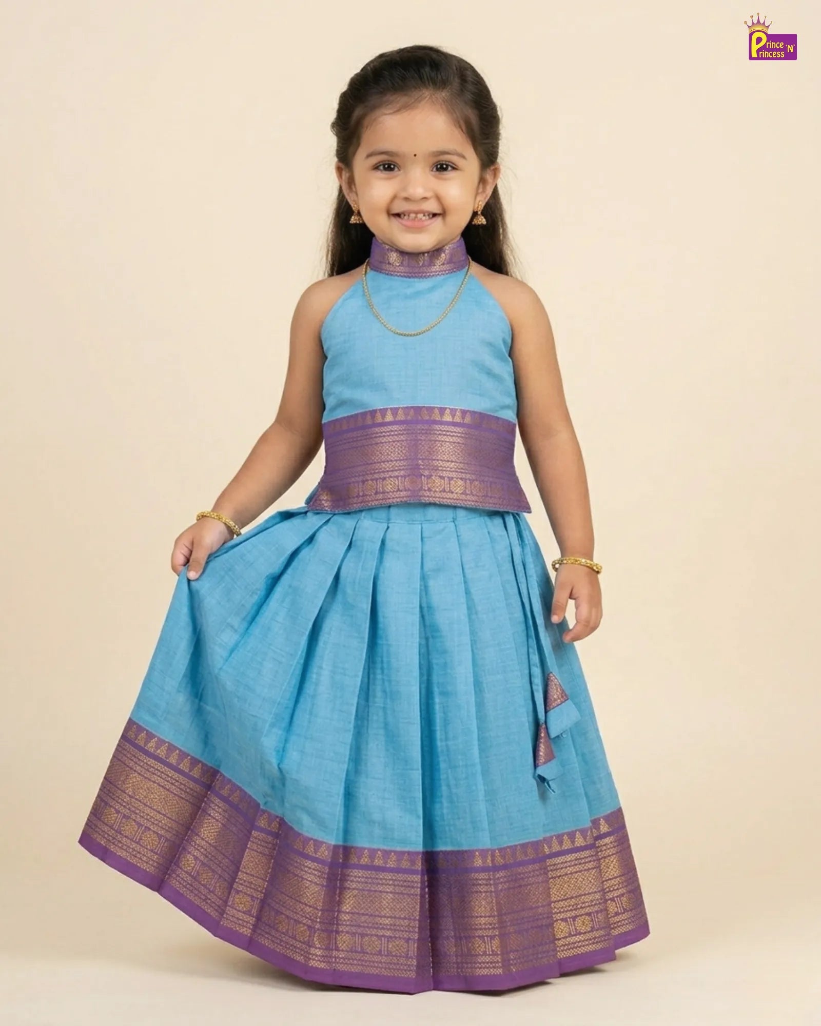 Young girl wearing a blue and purple traditional outfit on a beige background