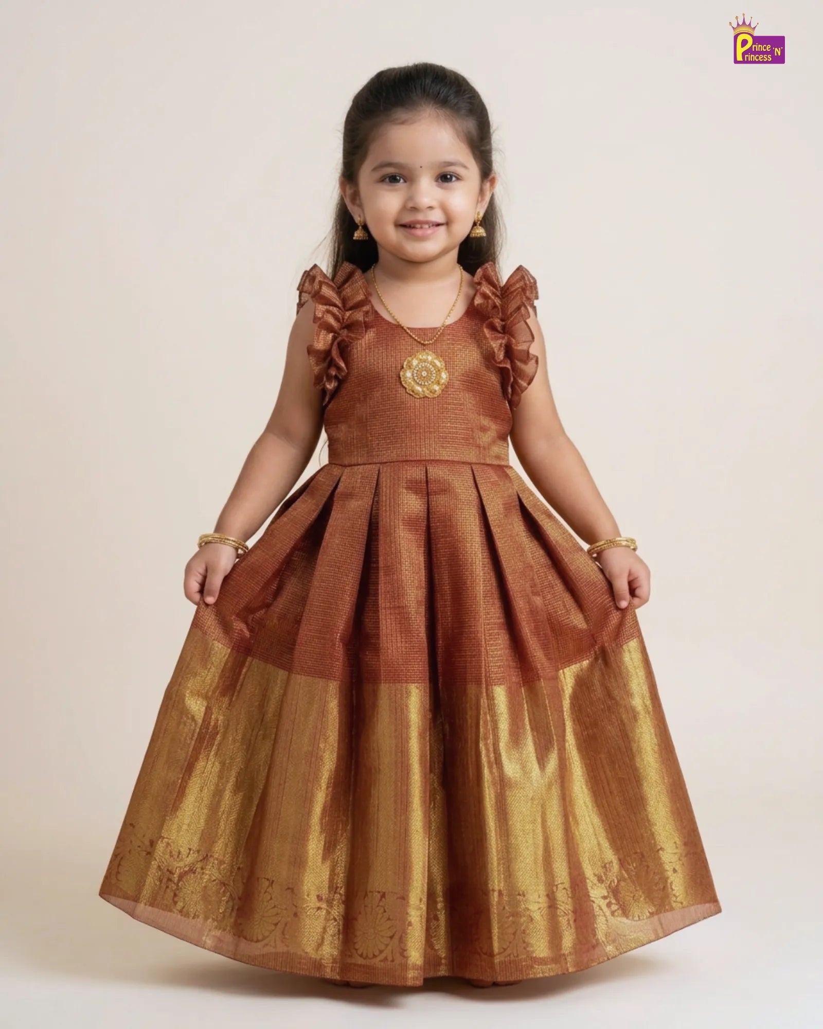 Young girl wearing a brown and gold dress on a white background