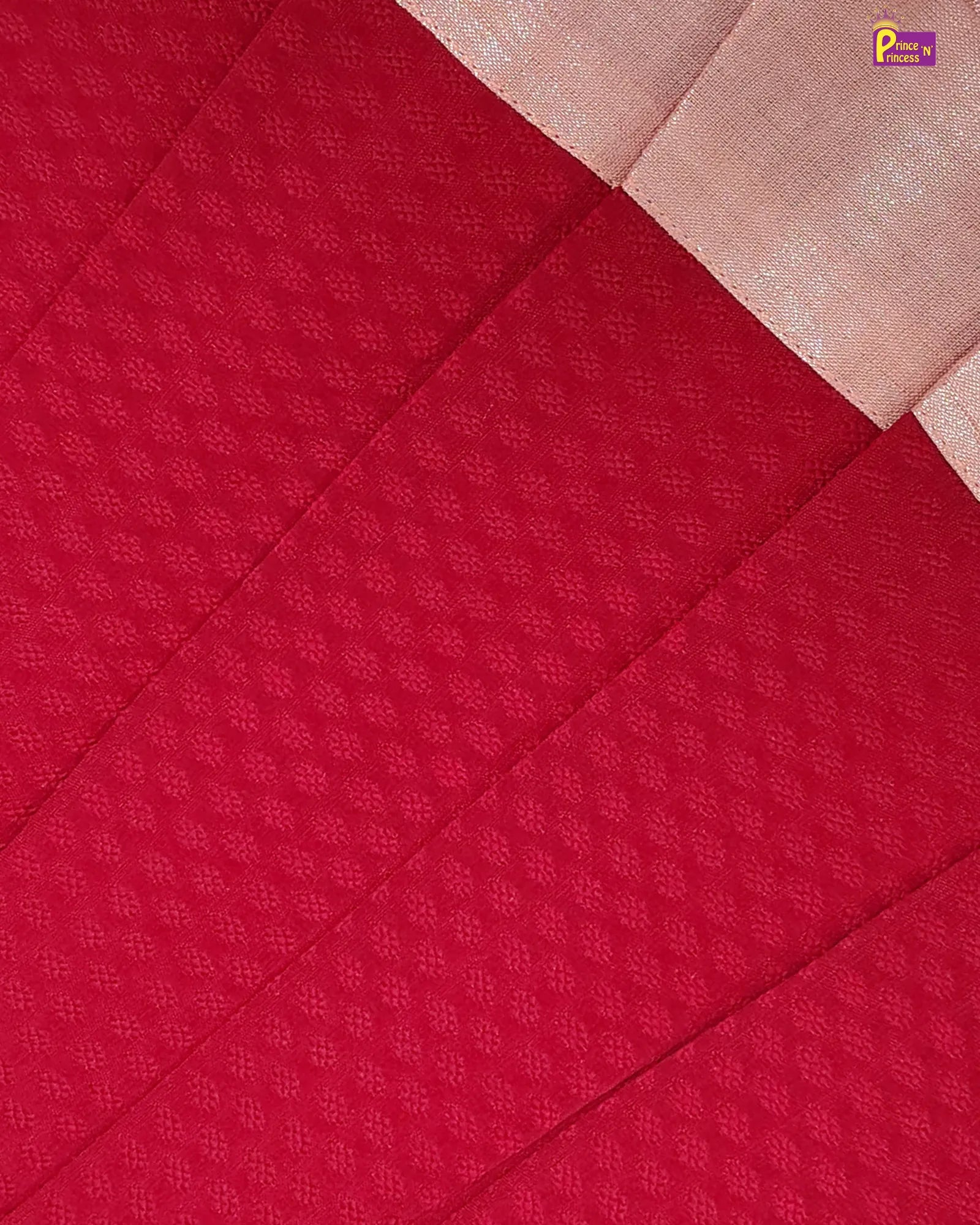Red fabric with a subtle pattern on a beige background