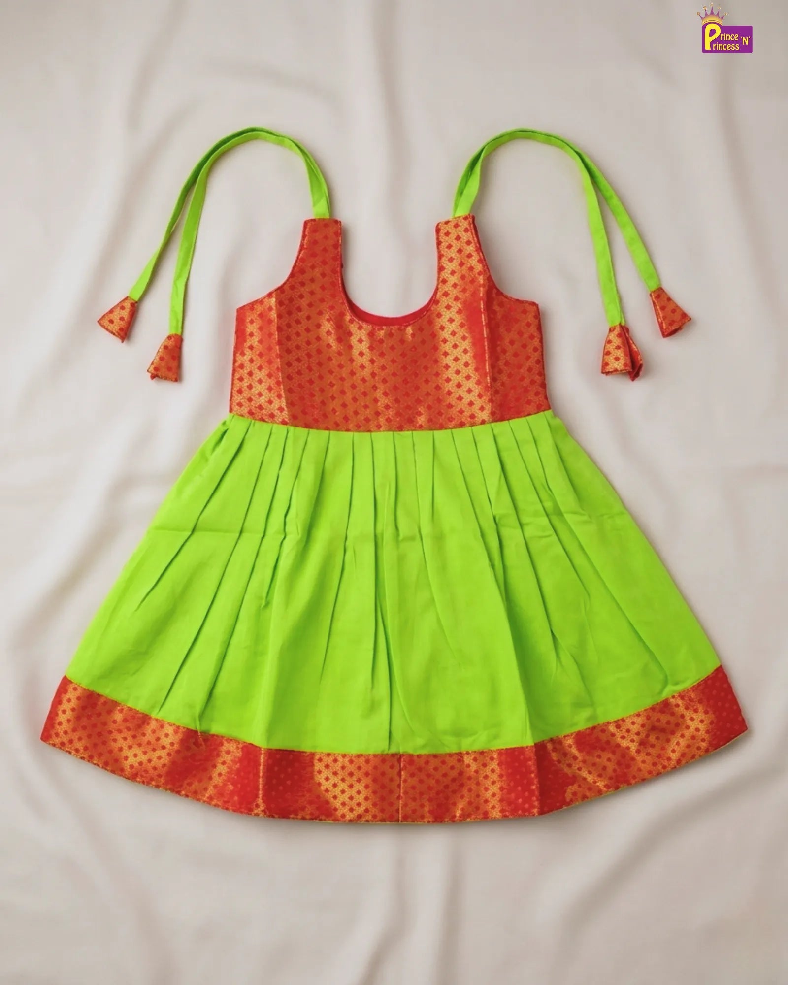 Colorful dress with green top and red bottom on a white background