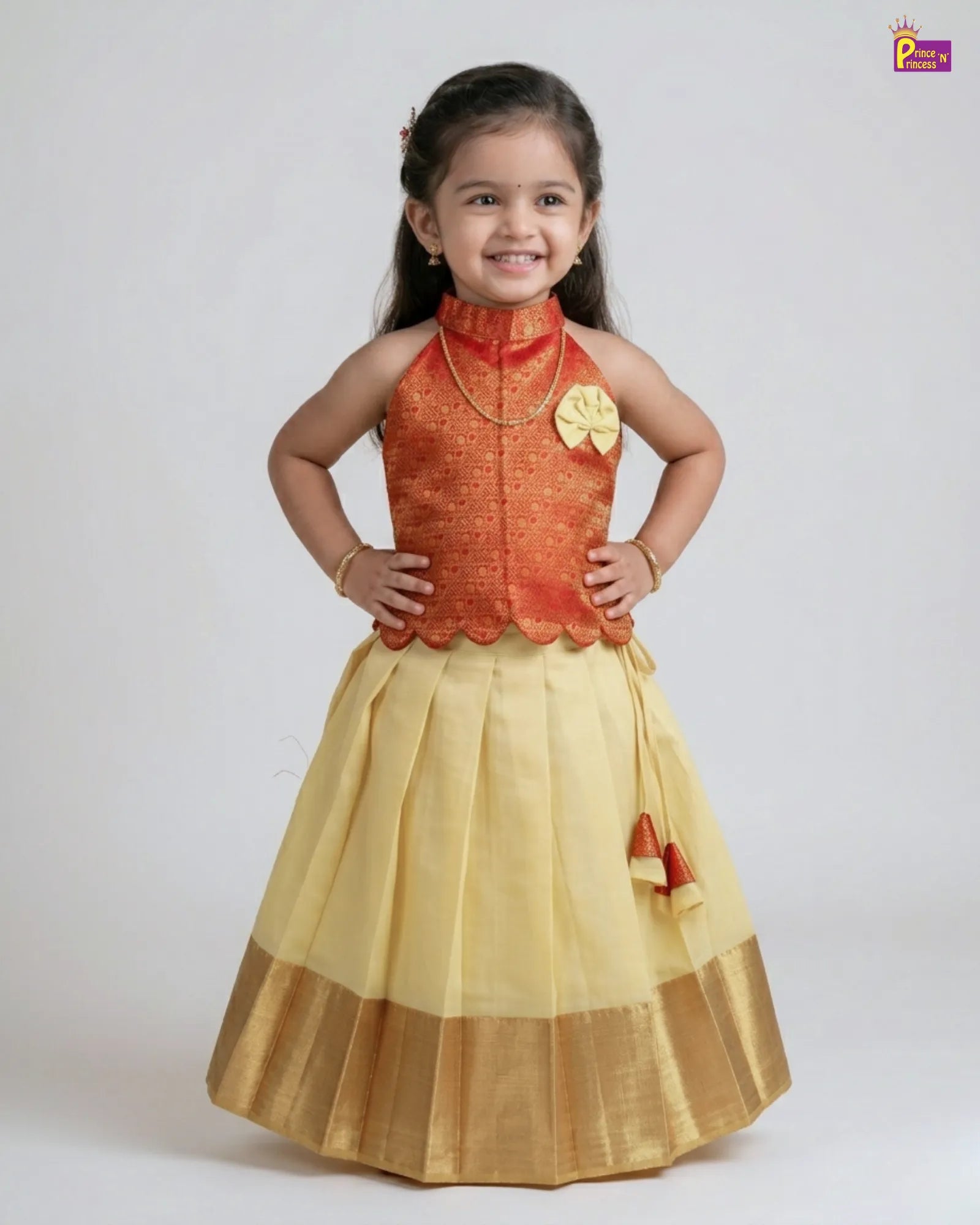 Young girl wearing a traditional outfit with an orange top and yellow skirt on a white background