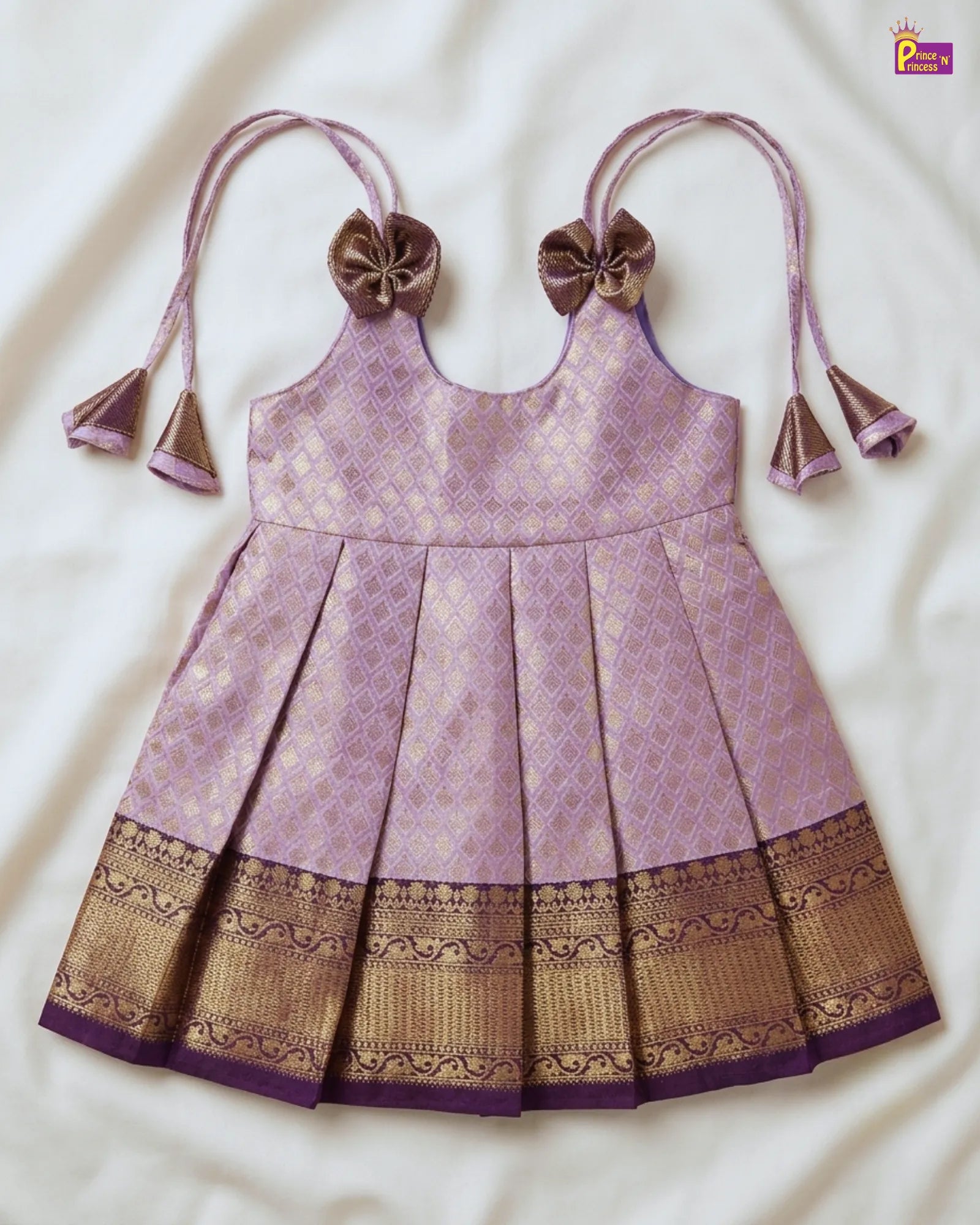 Purple and gold traditional dress with decorative elements on a white background