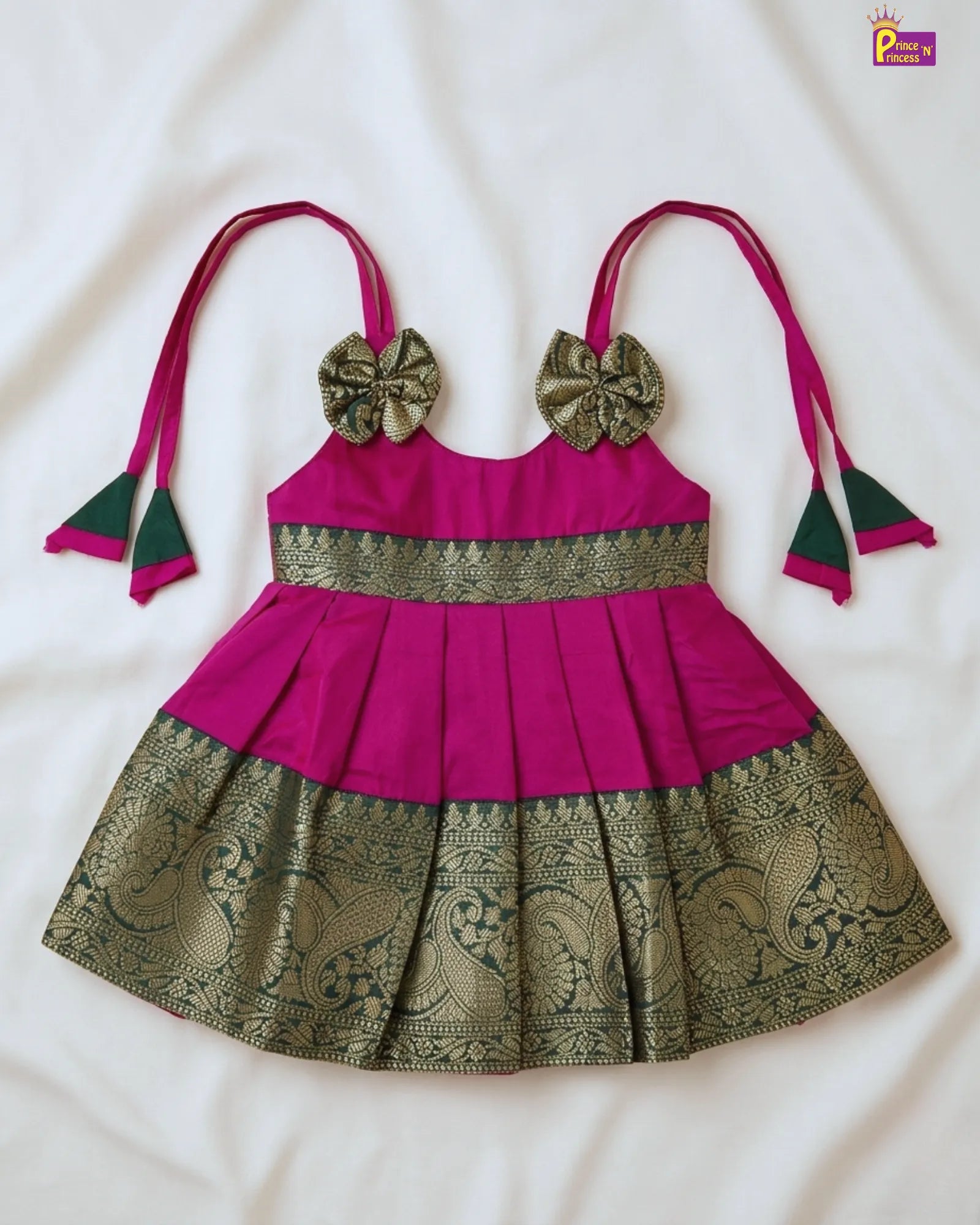 Pink and green traditional outfit with decorative elements on a white background