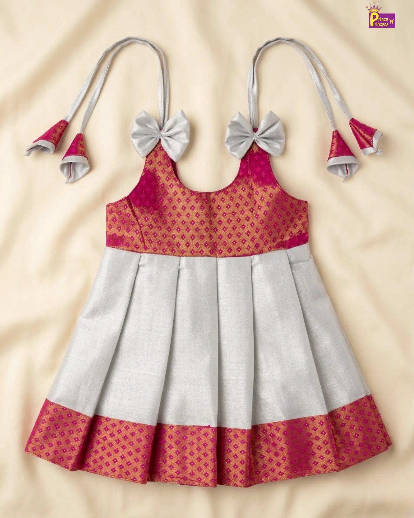 Children's dress with red and white pattern on a beige background