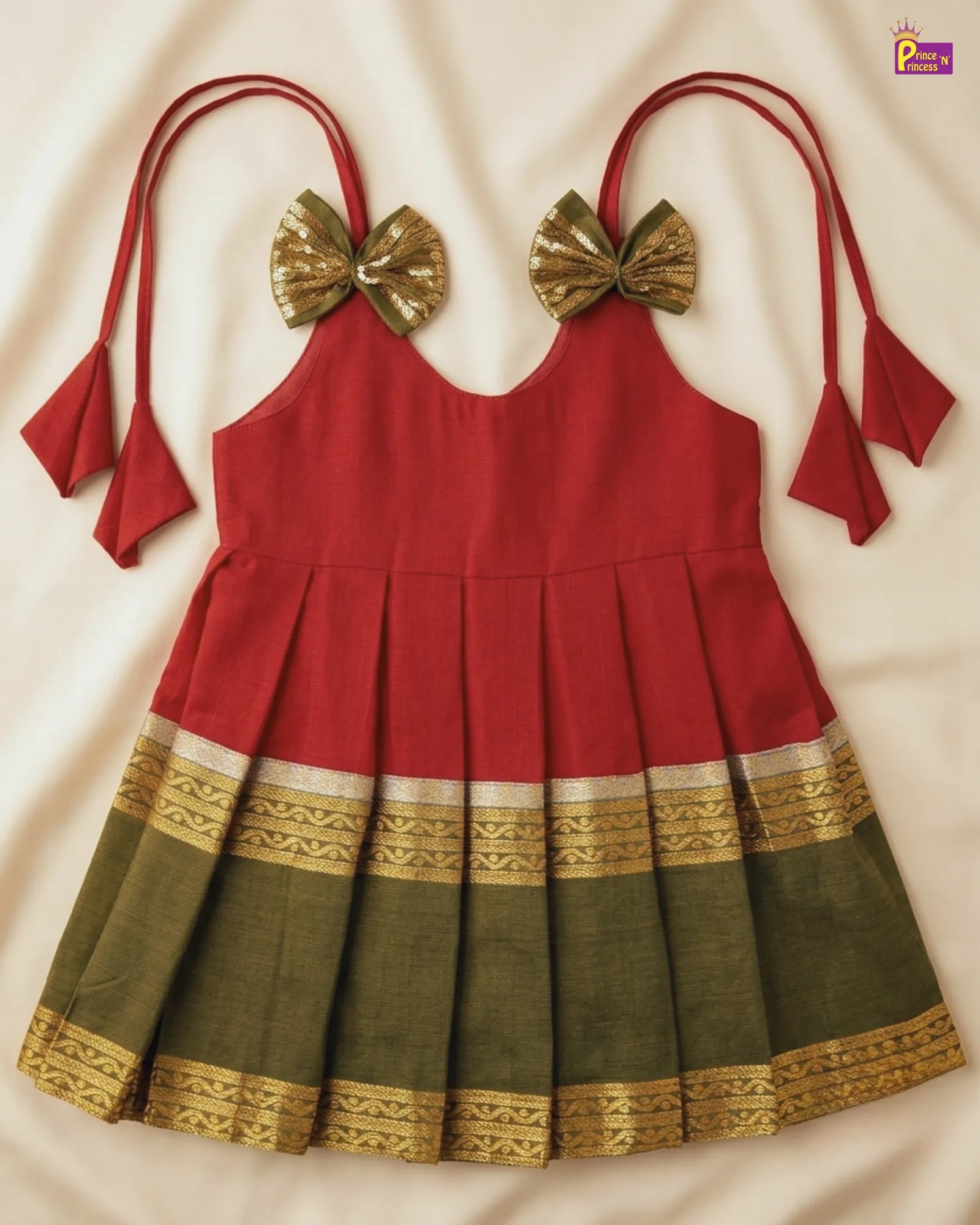 Red and green traditional dress with gold accents on a white background