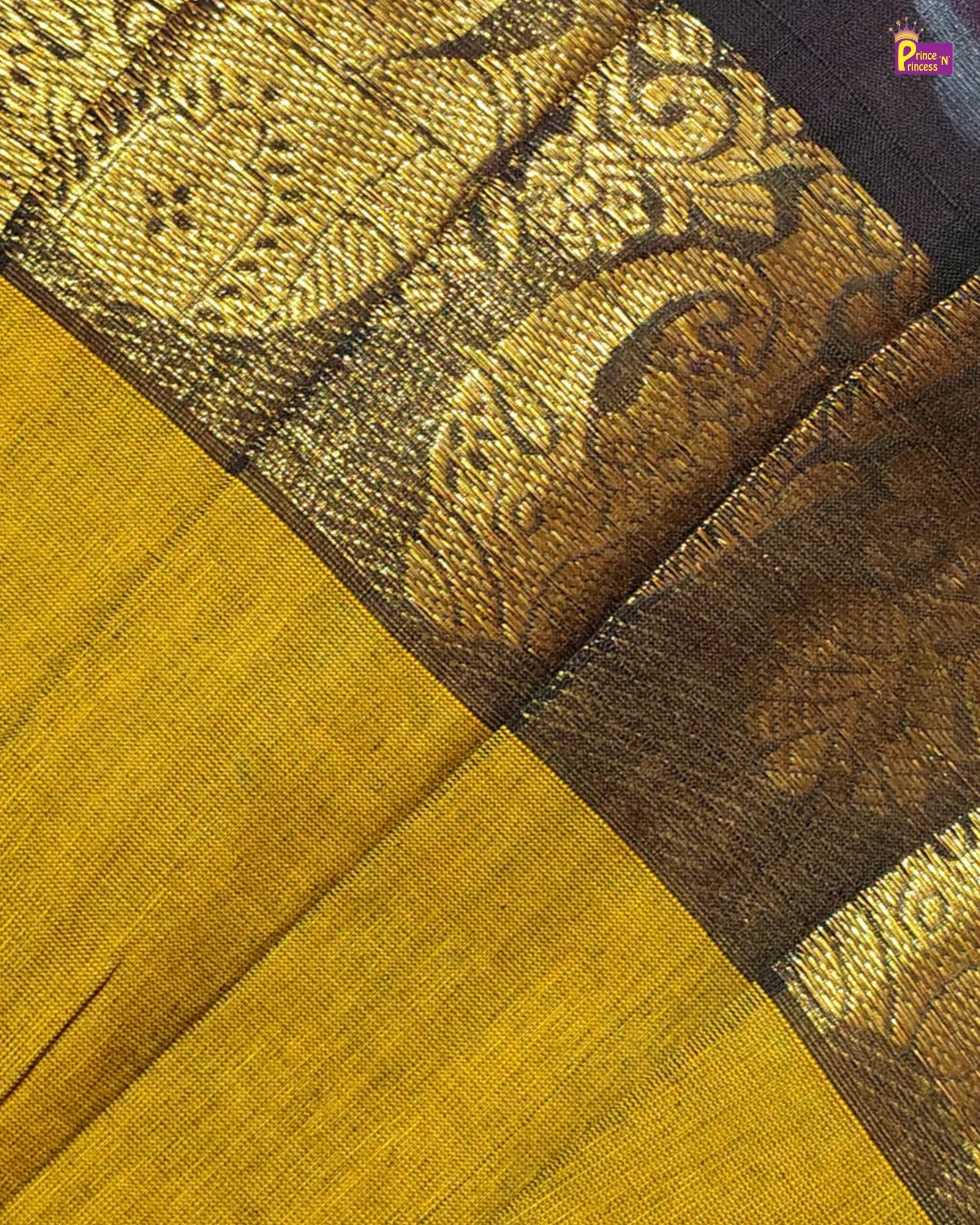 Close-up of a fabric with intricate patterns and colors, featuring a mix of brown and yellow.