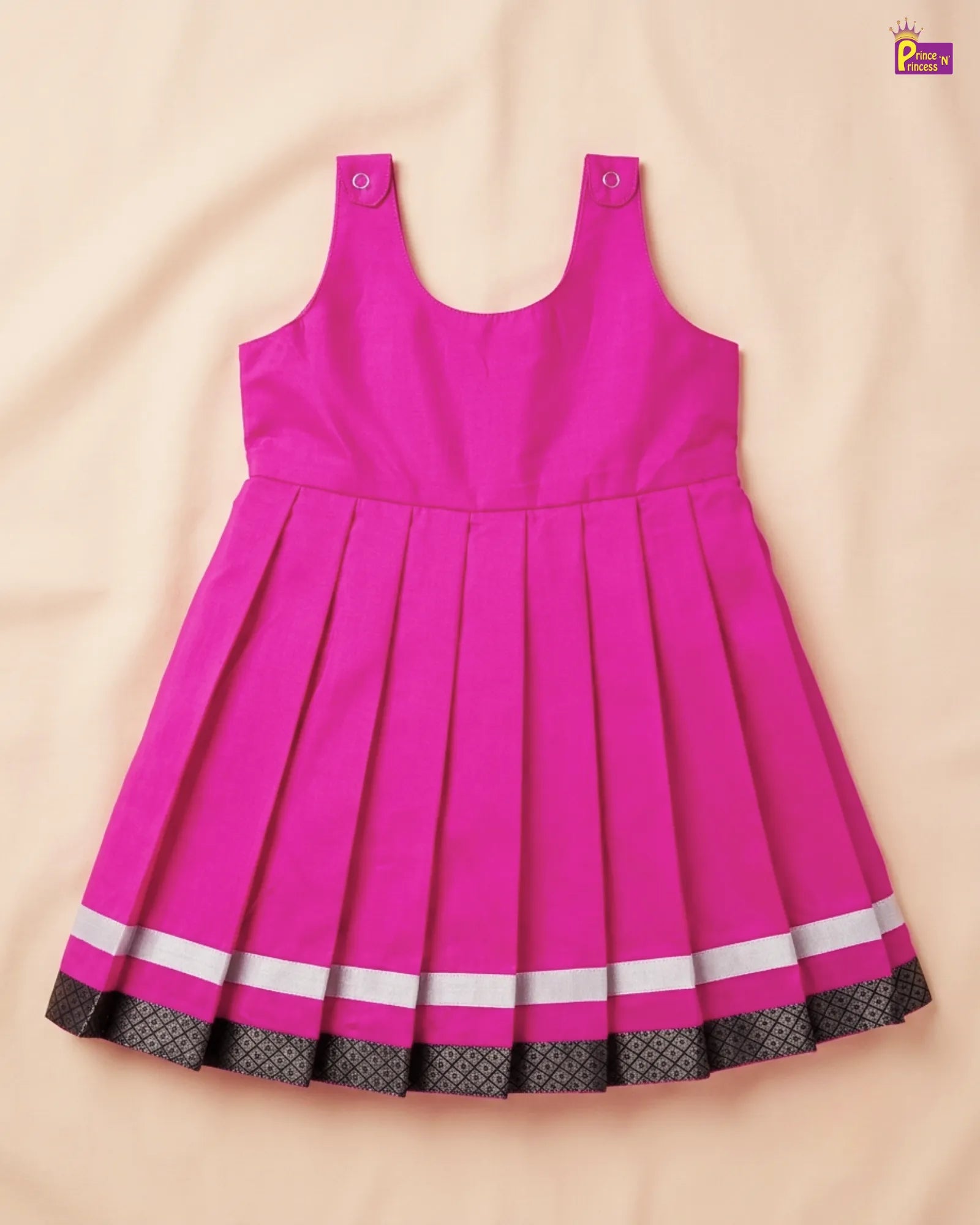 Pink dress with white and black trim on a beige background