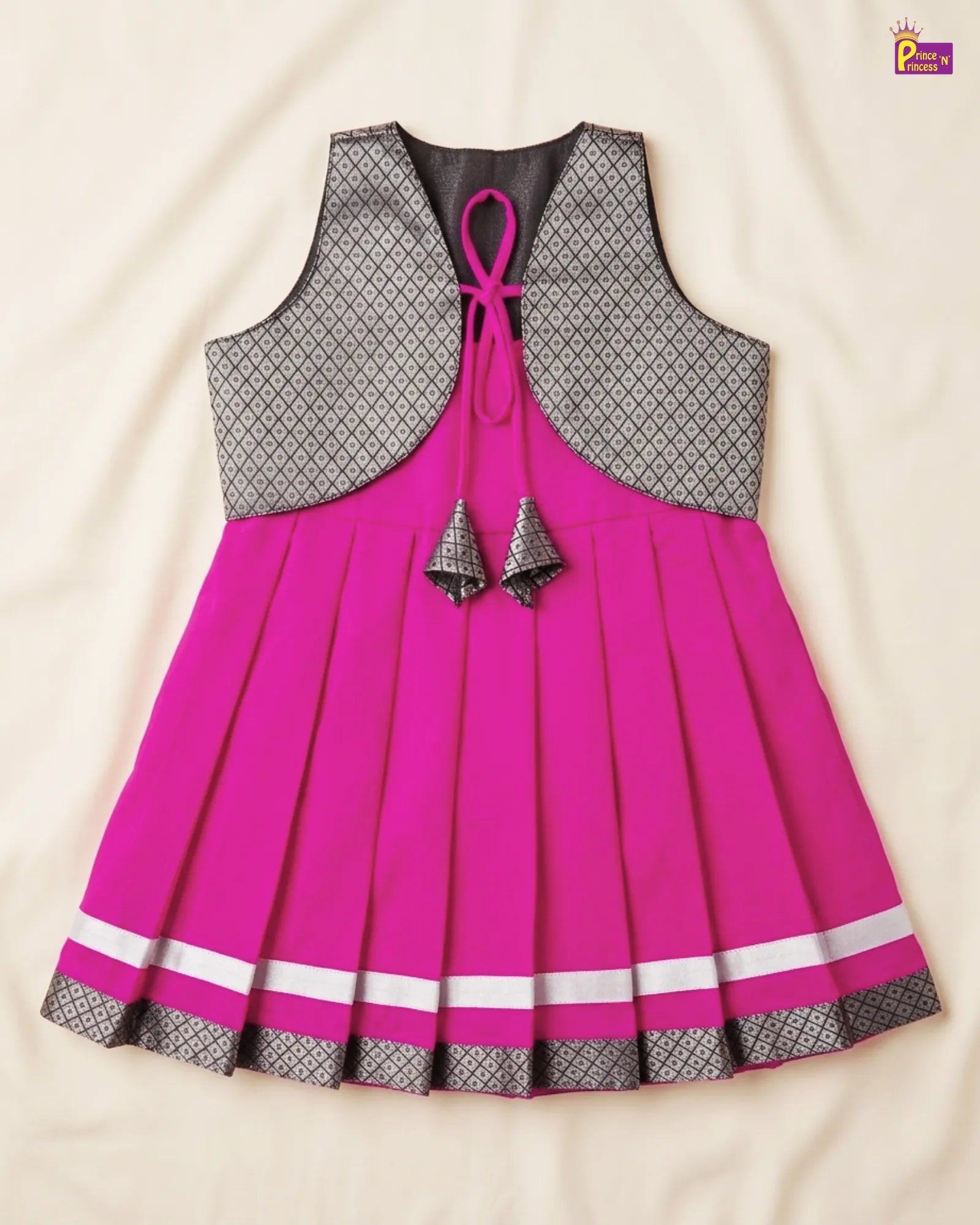 Pink dress with gray patterned top on a beige background