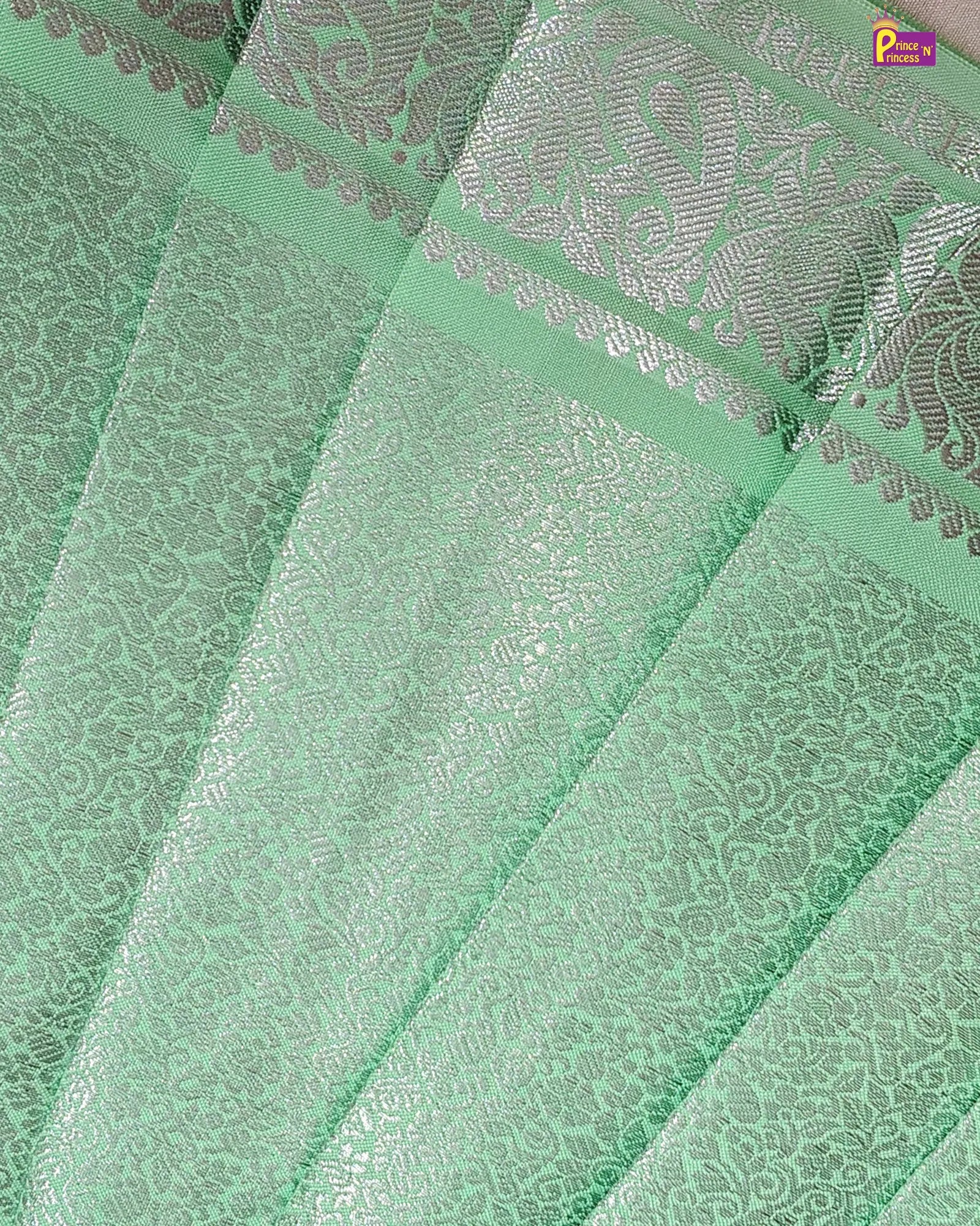 Green fabric with intricate silver patterns