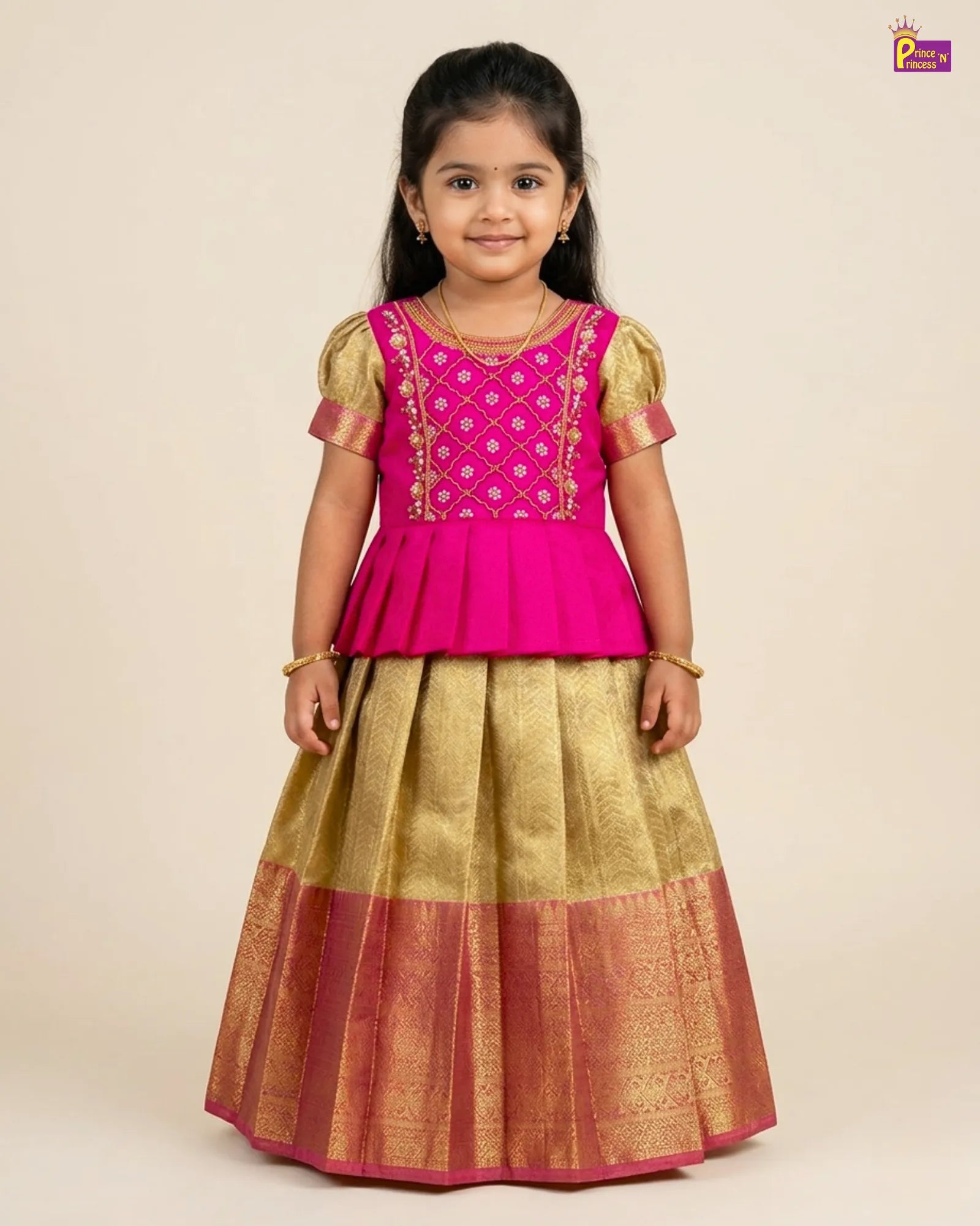 Young girl wearing a pink and gold traditional outfit on a beige background