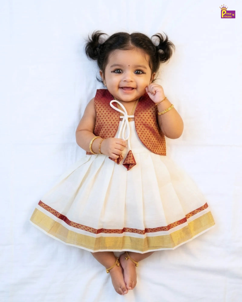 Baby girl in a traditional outfit with a white background