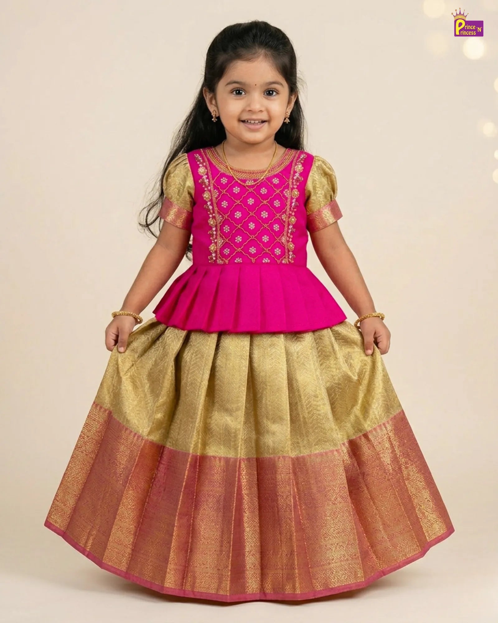 Young girl wearing a pink and gold traditional outfit on a beige background