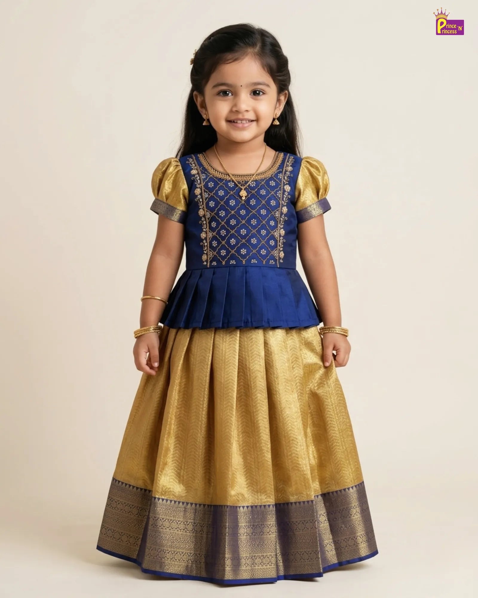 Young girl wearing a blue and gold traditional outfit on a beige background