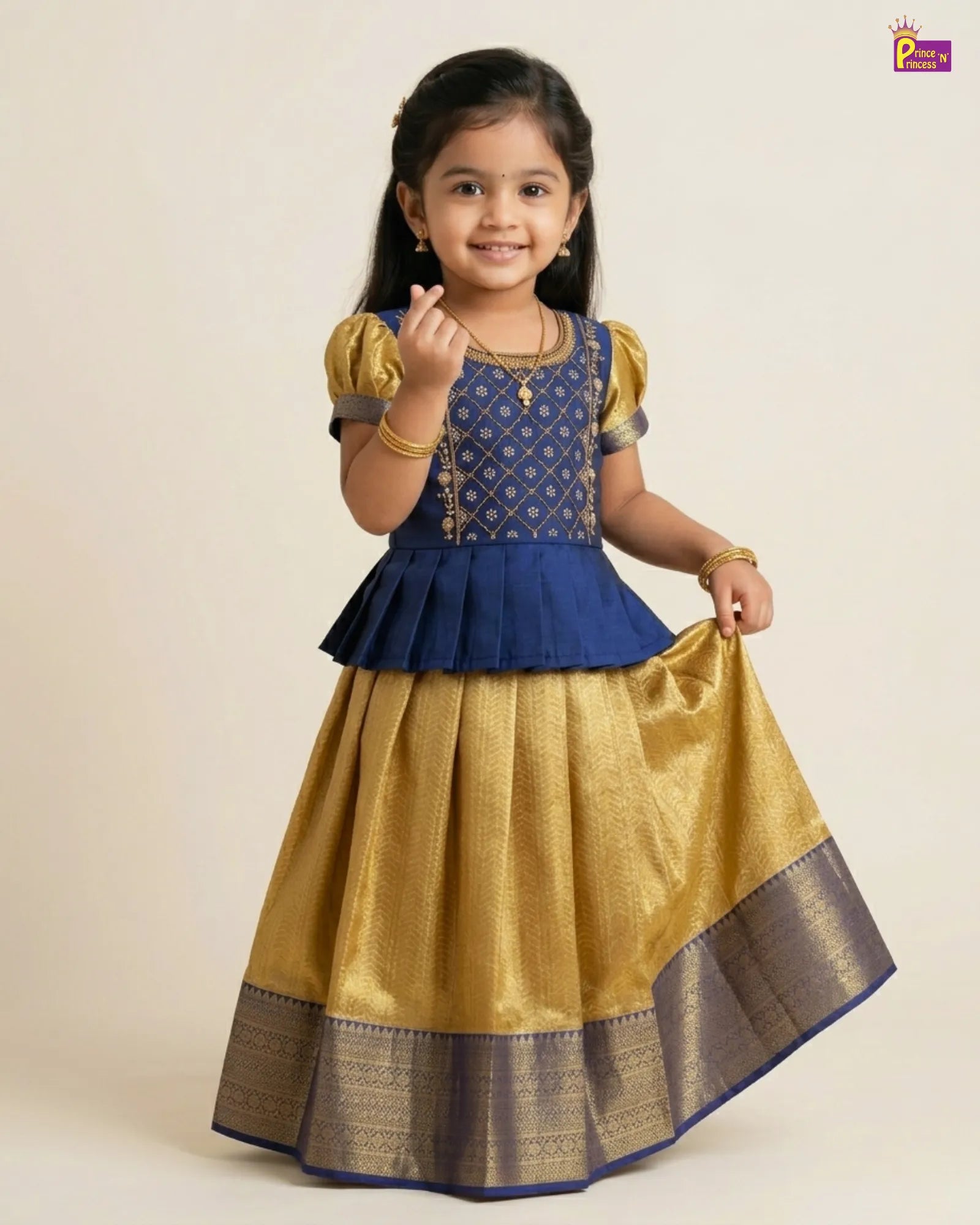 Young girl wearing a blue and gold traditional outfit on a beige background