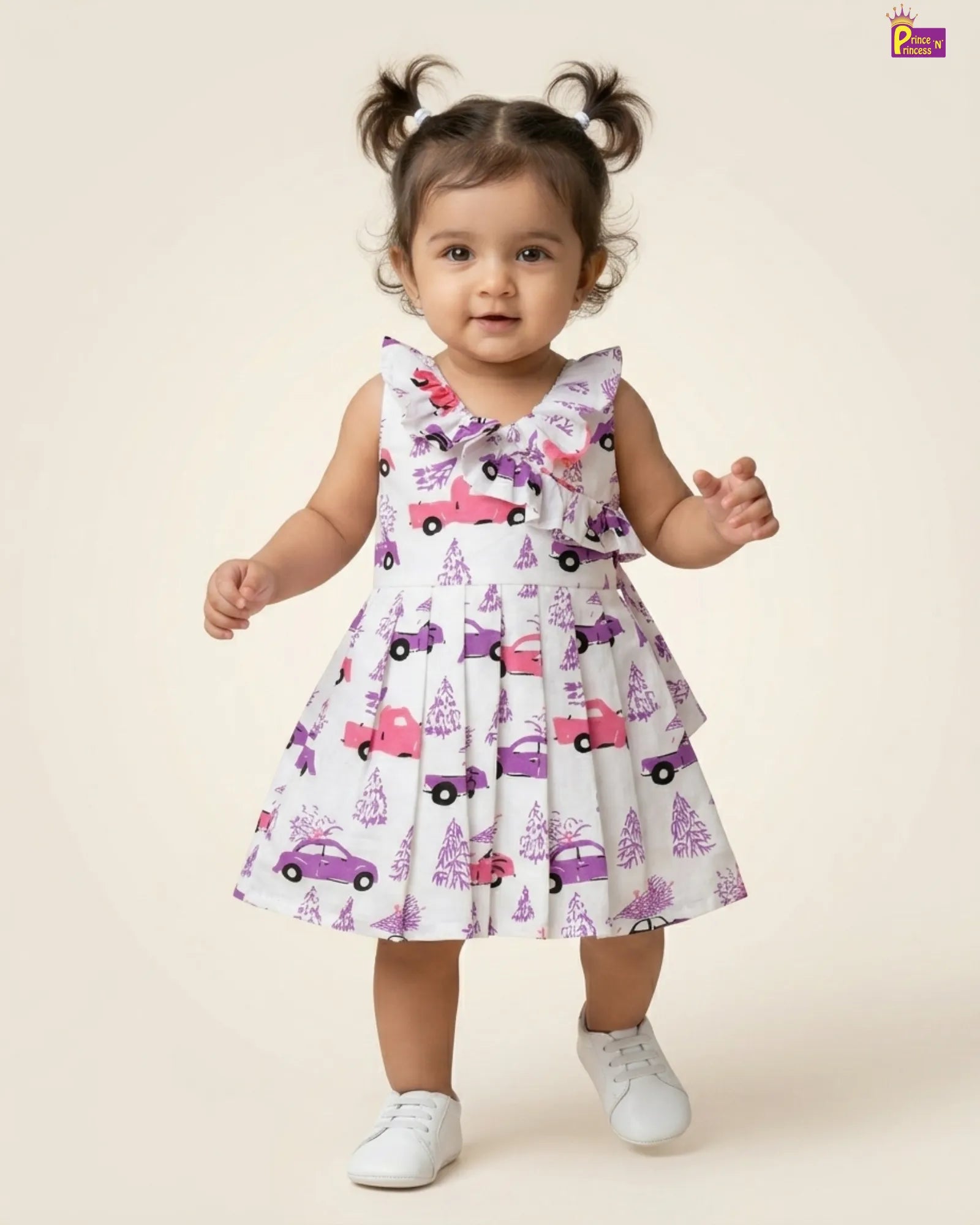 Child wearing a dress with car pattern on a plain background