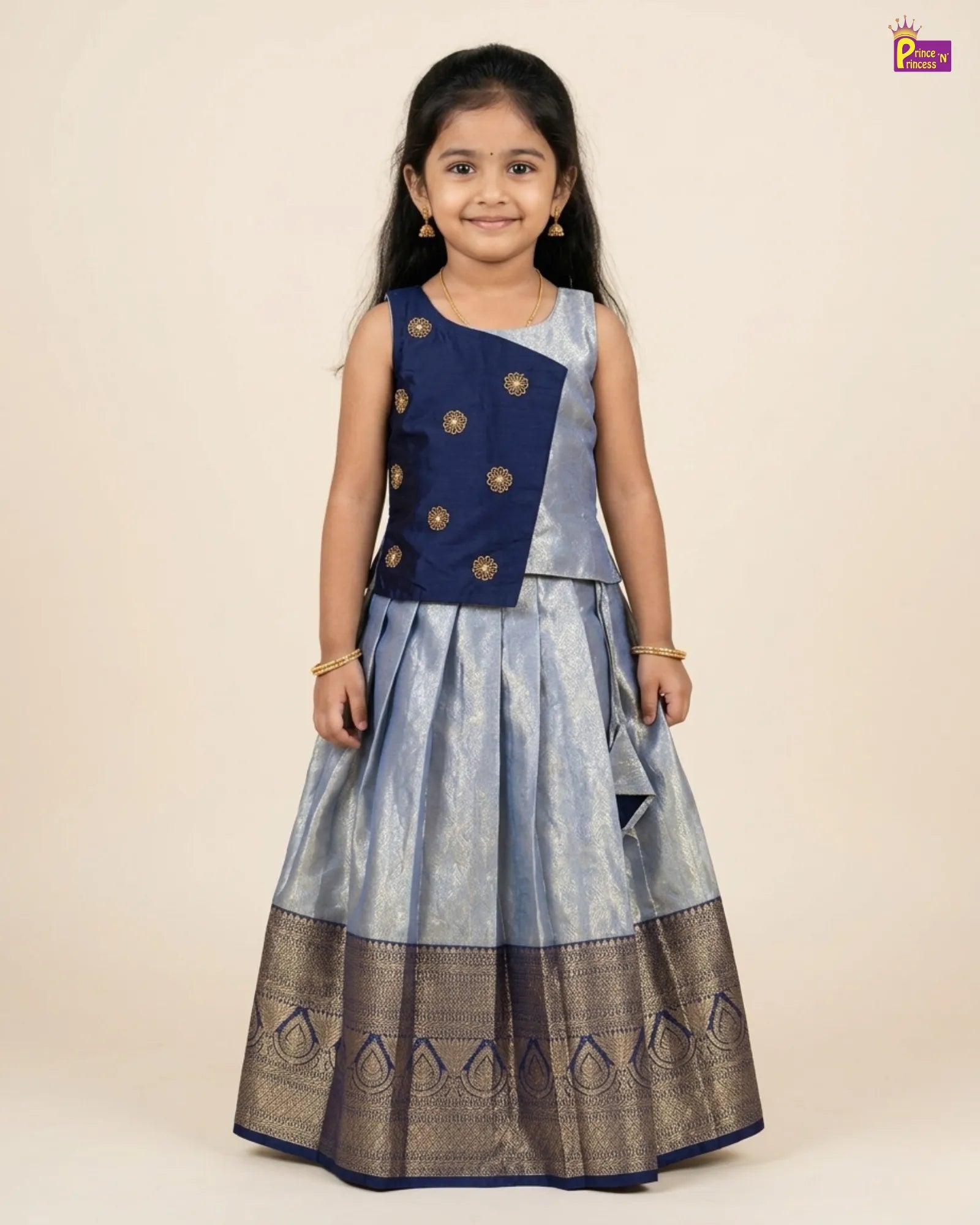 Young girl wearing a traditional outfit with a blue top and gray skirt on a beige background