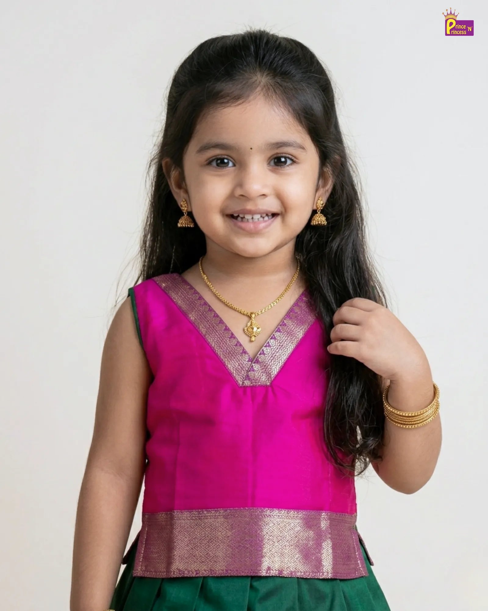 Young girl wearing a pink blouse with a green skirt against a white background