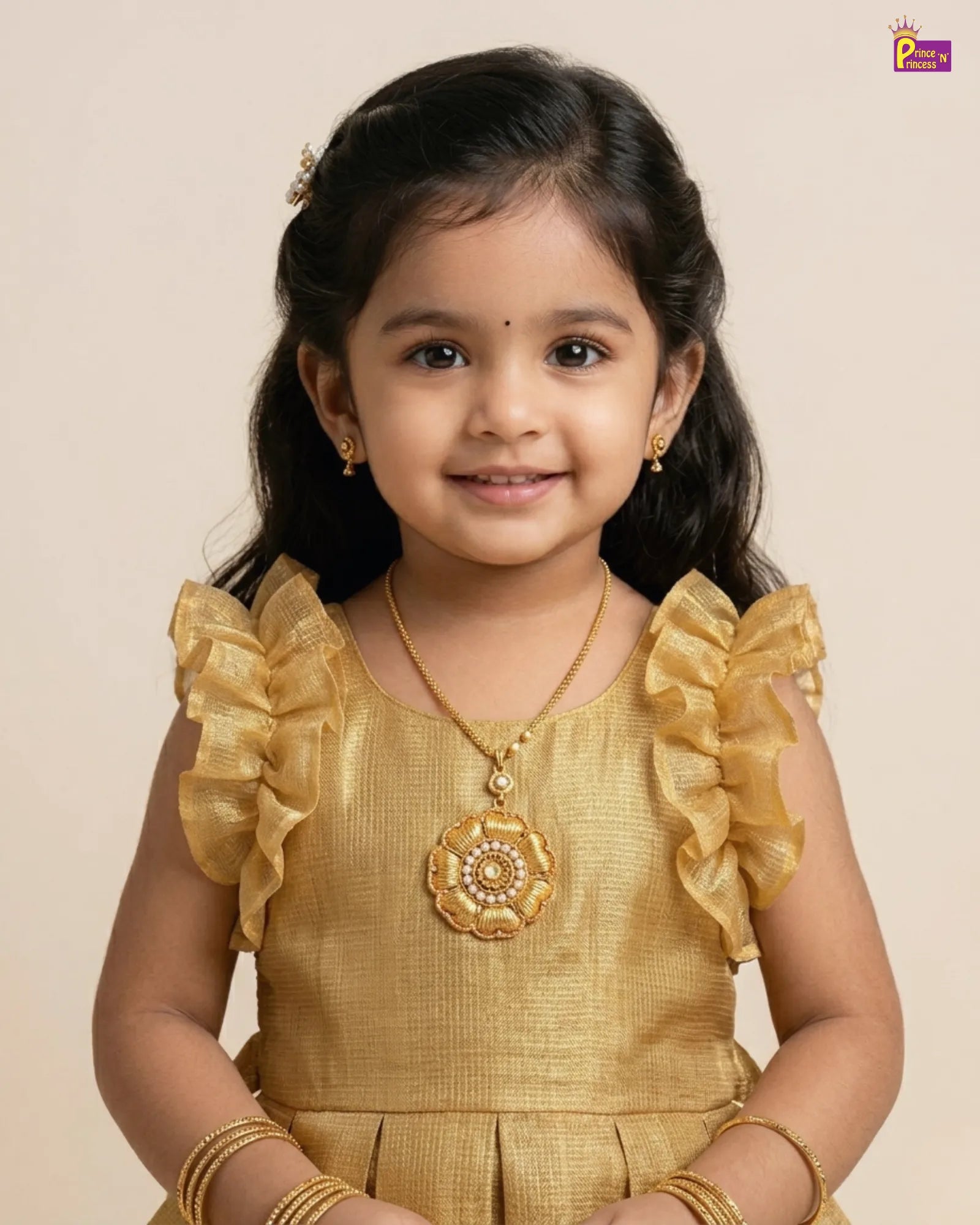 Young girl in a gold traditional outfit with jewelry on a beige background