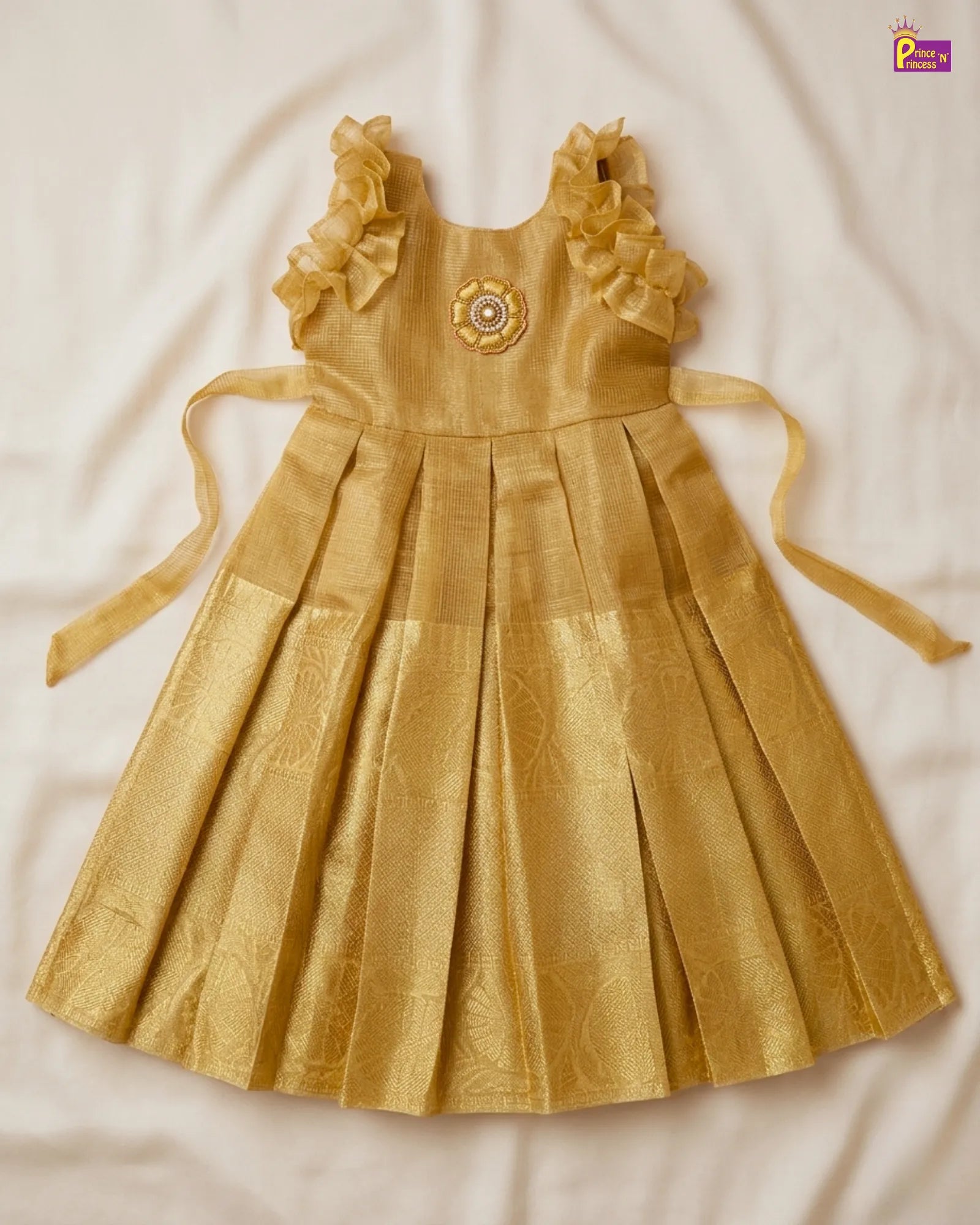 Gold dress with ruffled straps on a white background