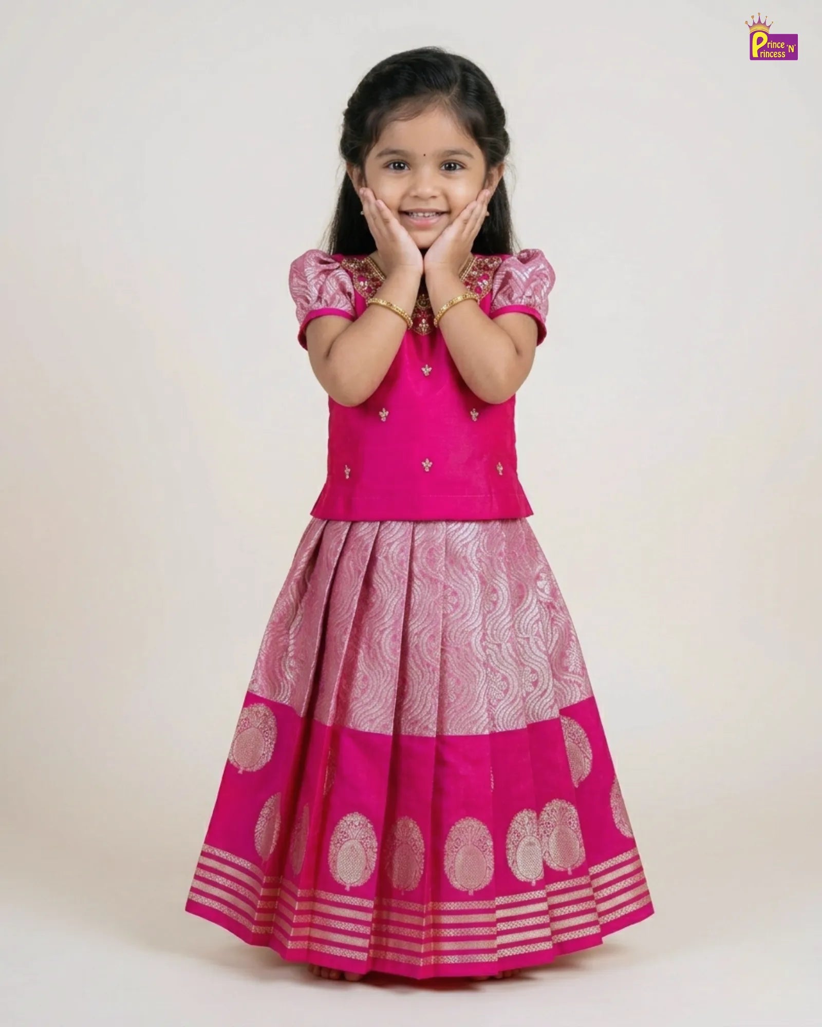 Young girl wearing a pink traditional outfit with a white background