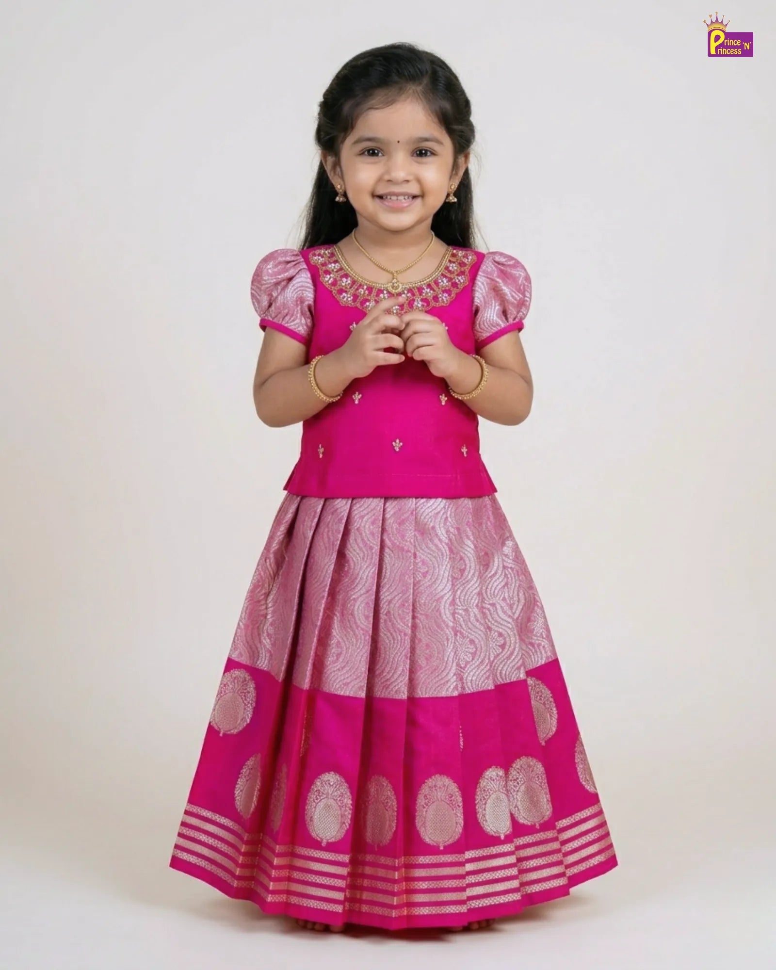 Young girl wearing a pink traditional outfit with a white background