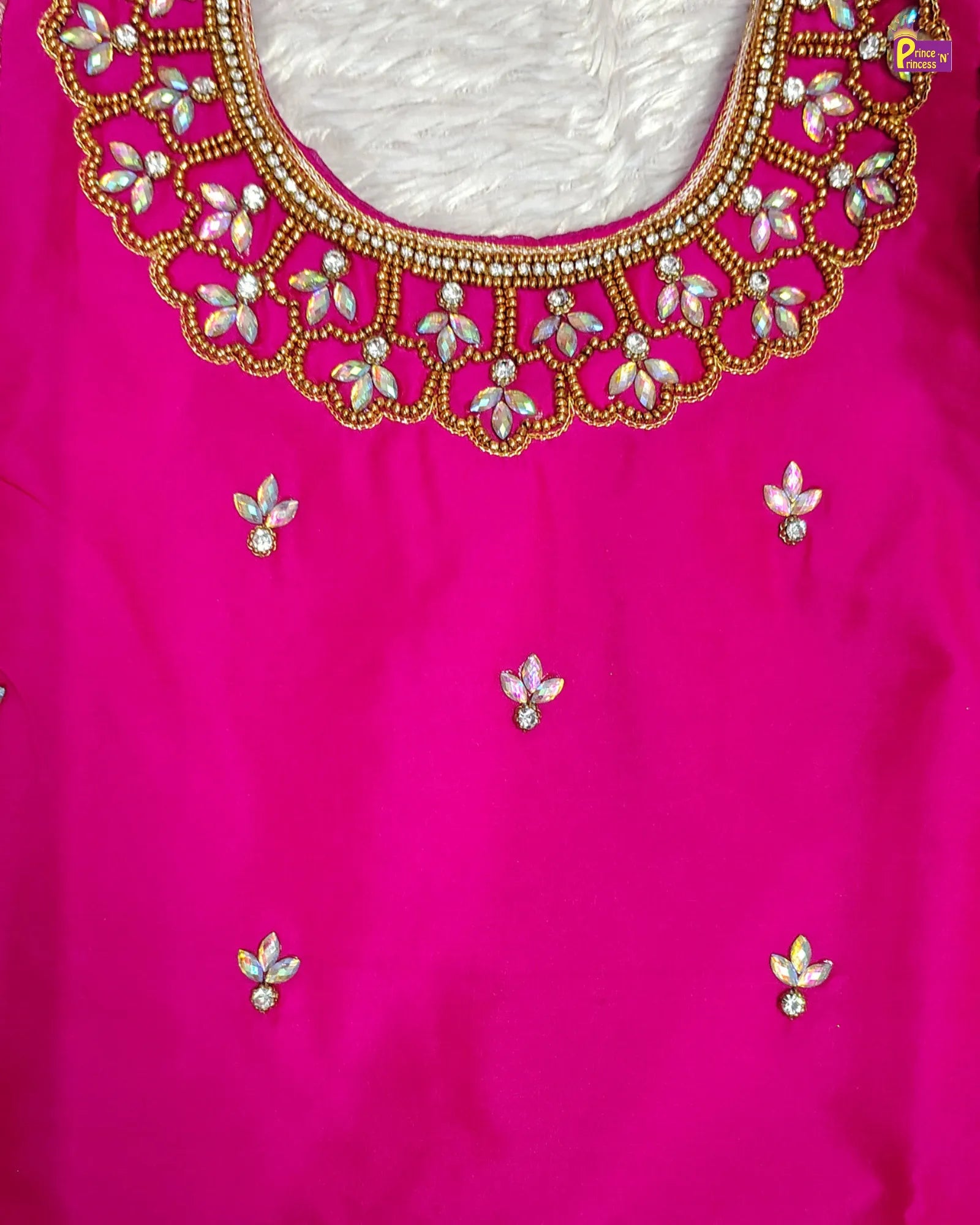 Pink blouse with intricate gold and white embroidery