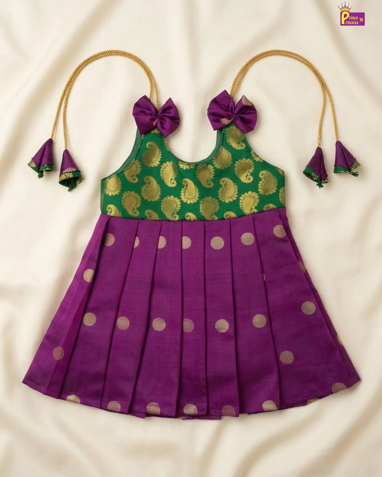 Purple dress with green and gold pattern on a white background
