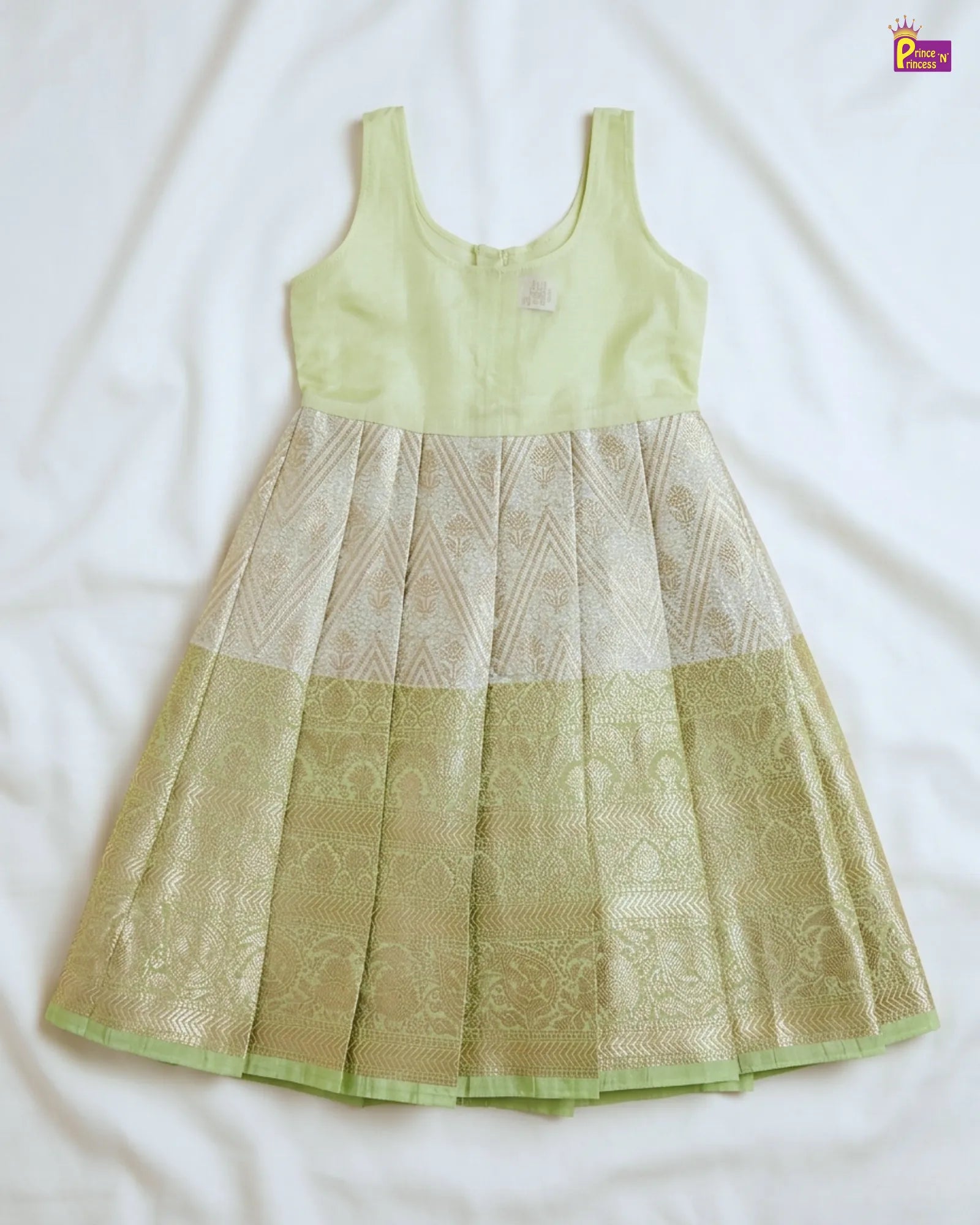 Light green dress with patterned design on a white background