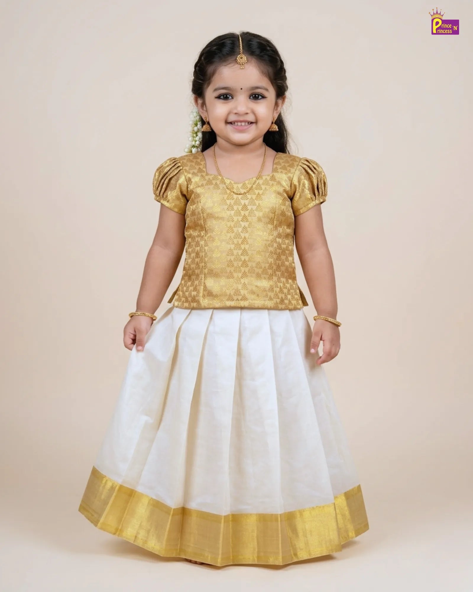 Young girl wearing a gold top and white skirt with gold border on a beige background