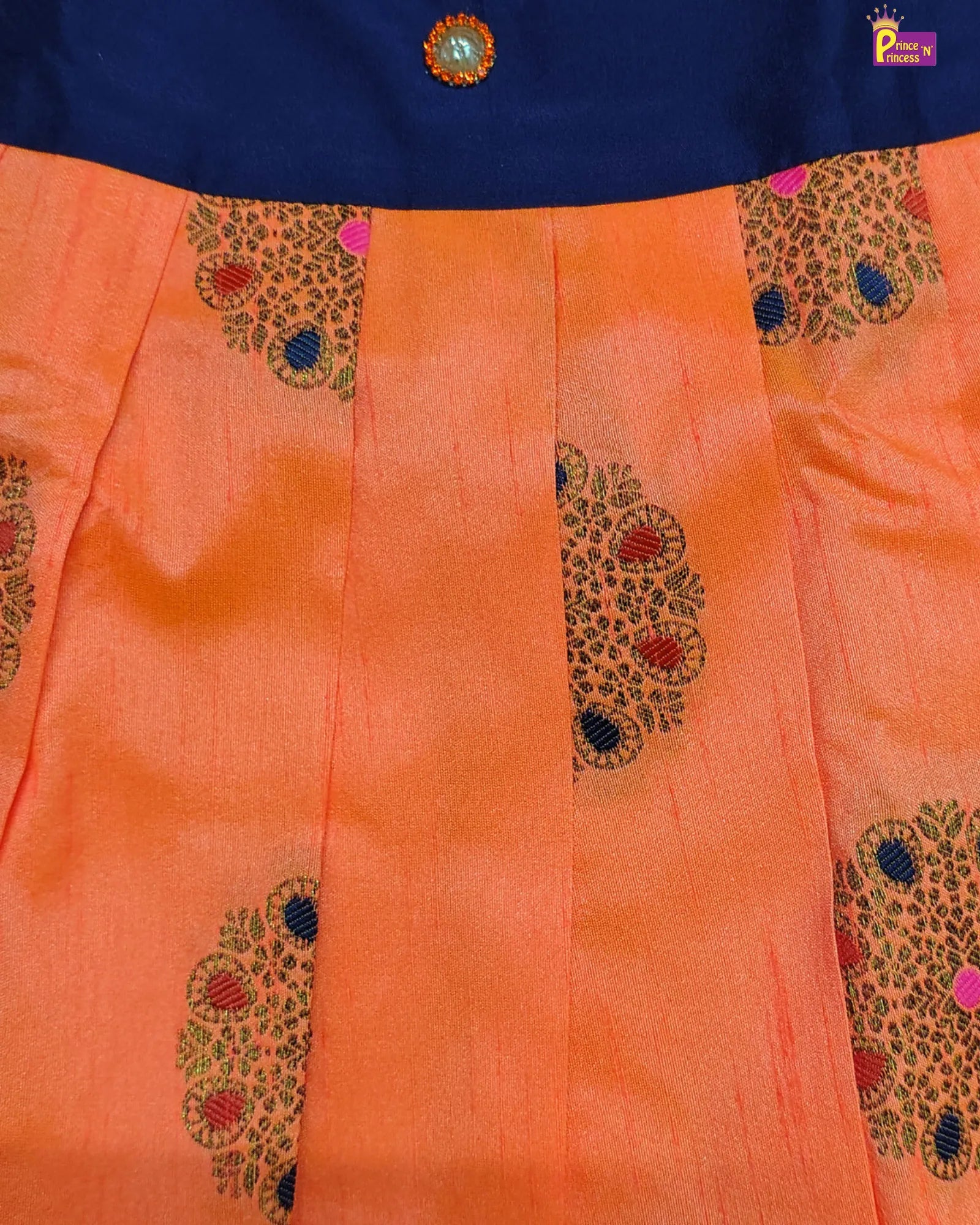 Orange fabric with intricate patterns and a blue section at the top