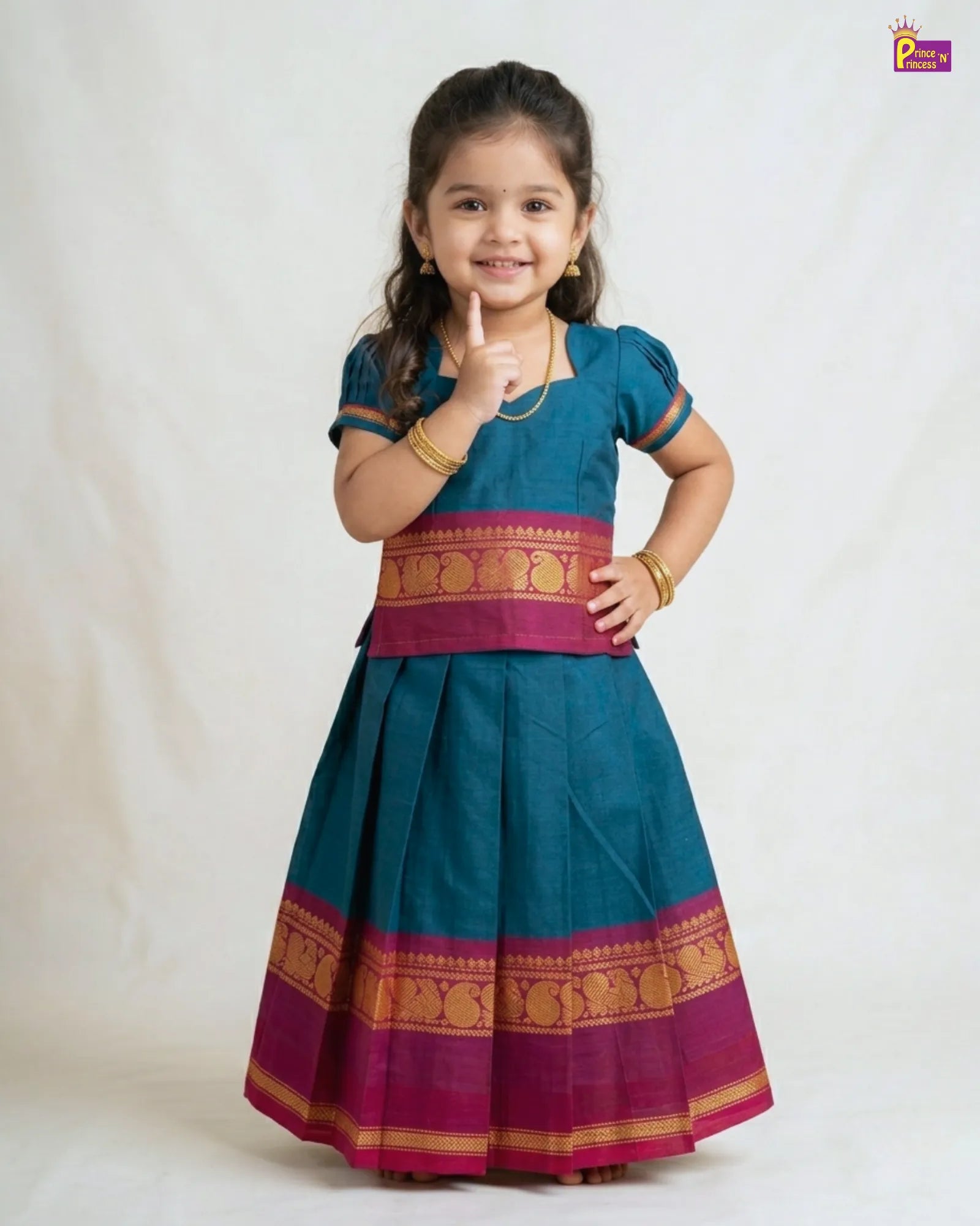 Young girl wearing a traditional outfit with a blue and pink design on a white background