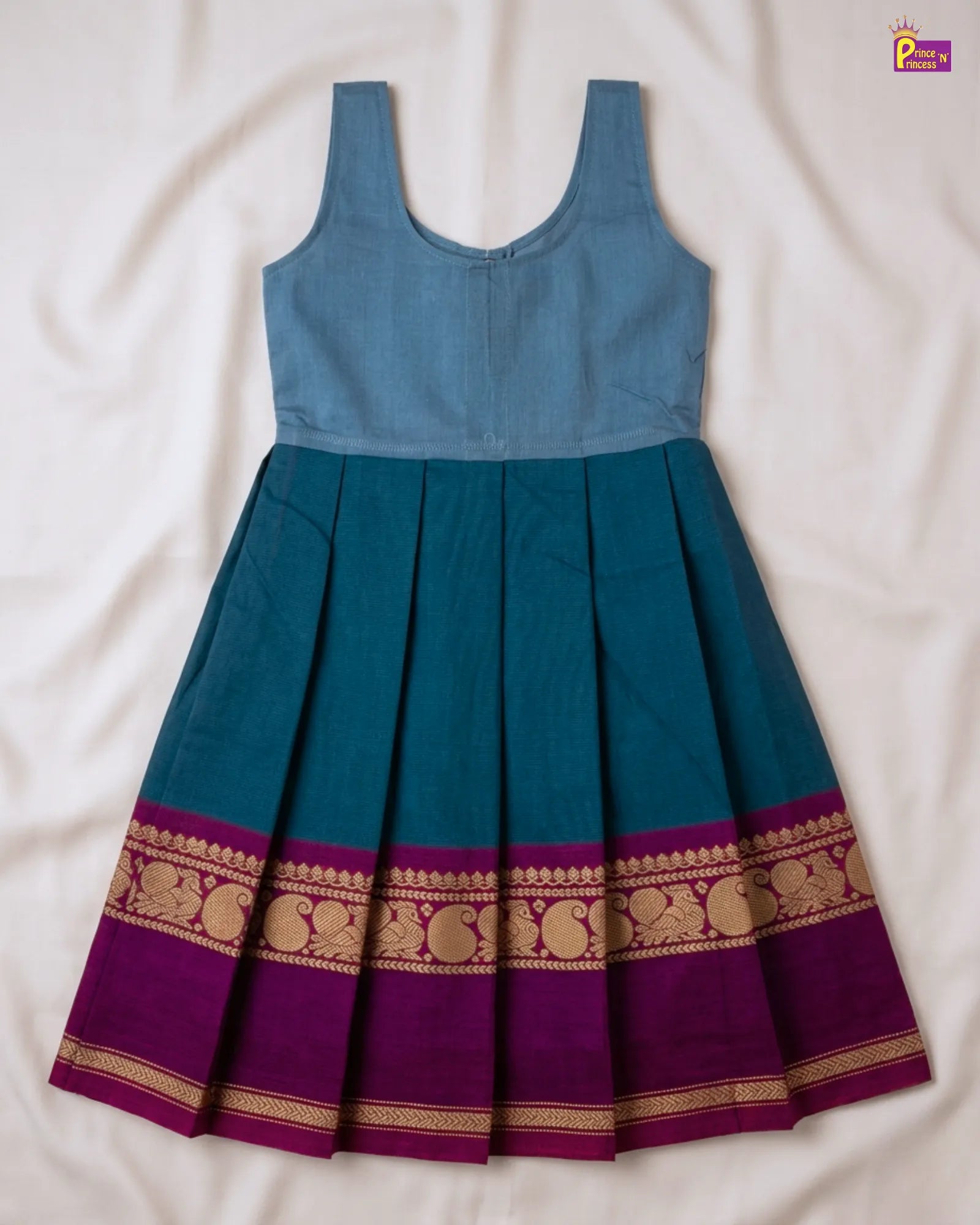 Blue and purple dress with gold patterns on a white background