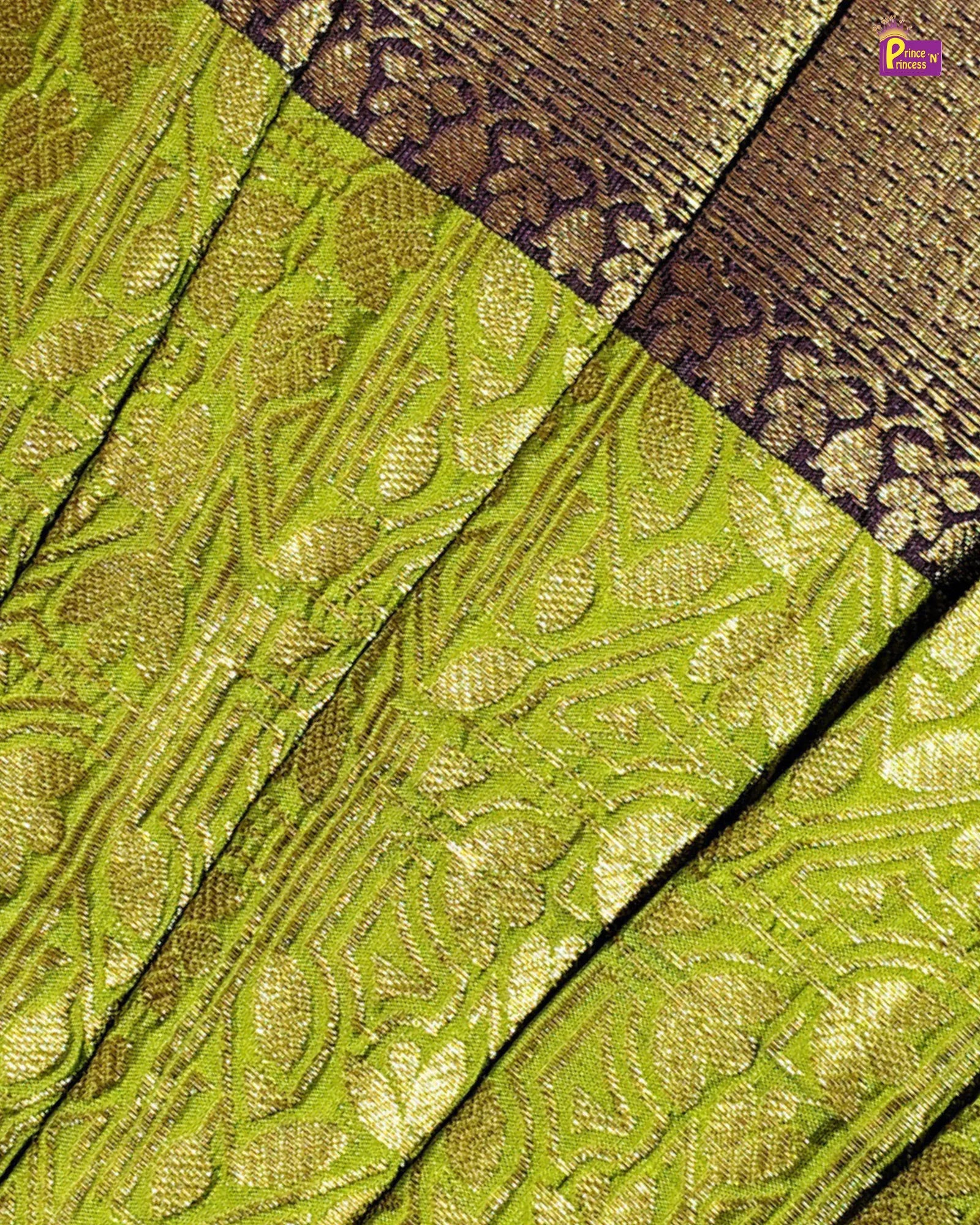 A close-up of a woven fabric with a bright chartreuse green base and metallic gold floral patterns, featuring a contrasting dark brown and gold patterned border.