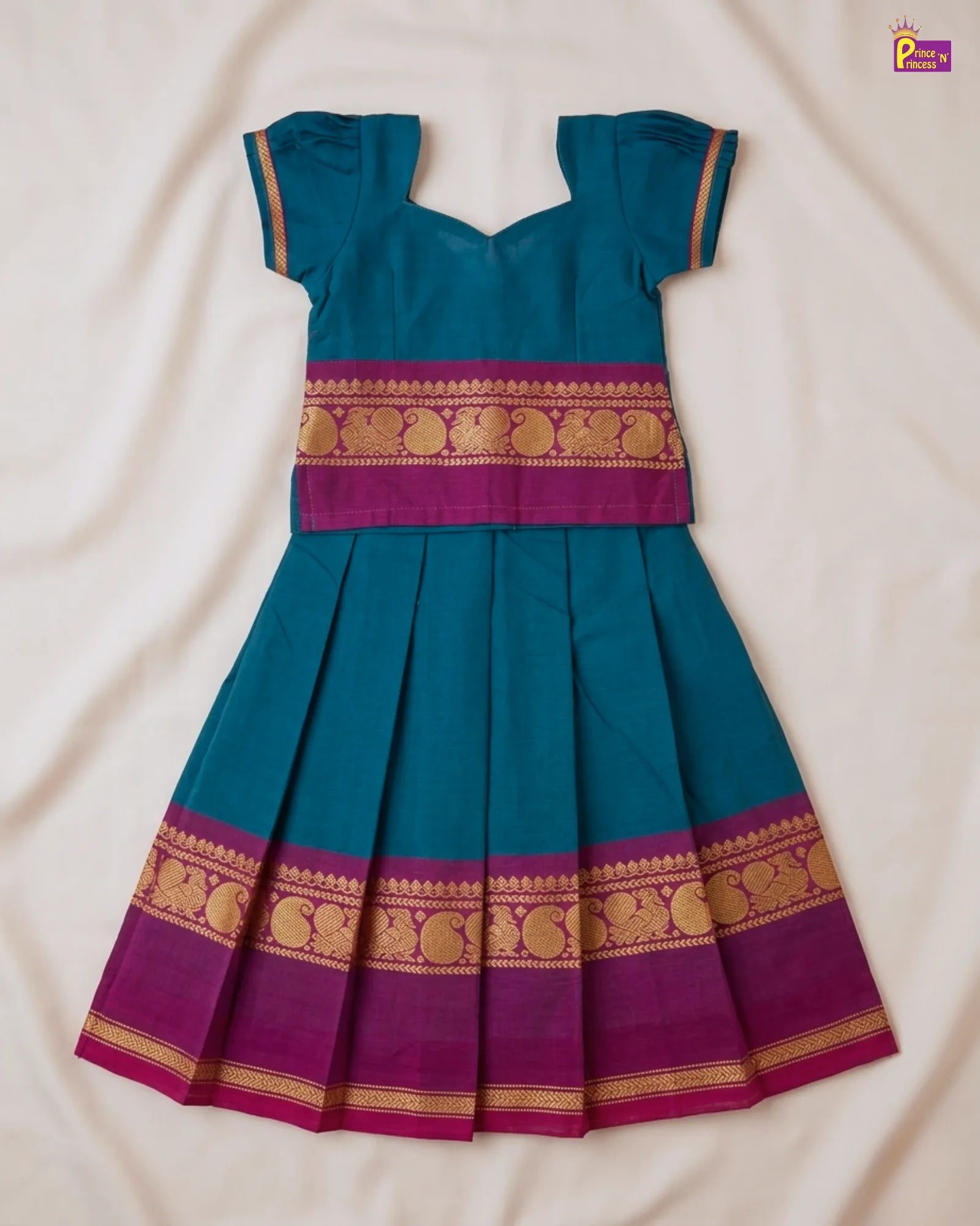 Teal and purple traditional dress with gold patterns on a beige background