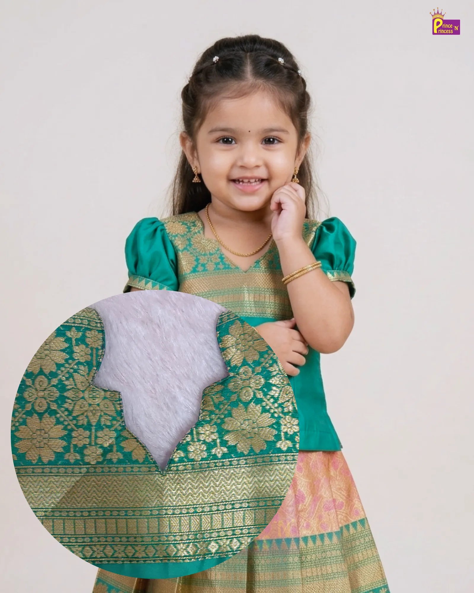 A young girl wearing a traditional Indian outfit with a green and gold embroidered top and a pink and gold skirt, holding a circular close-up detail of the fabric pattern.