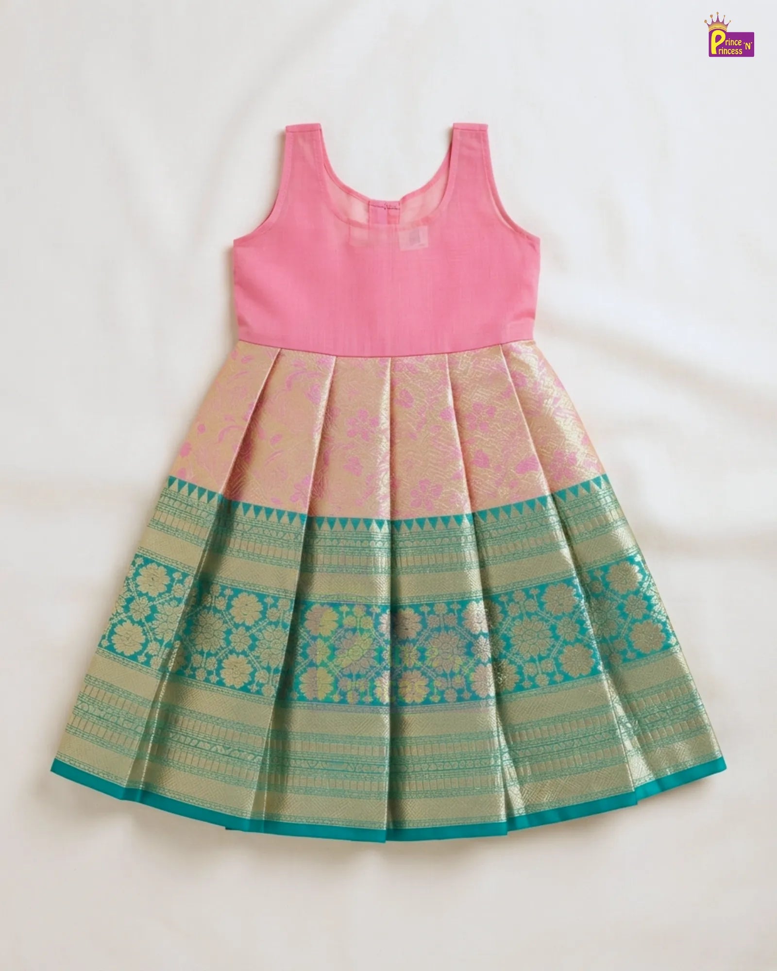 A sleeveless pink and gold Banarasi-style skirt dress with a pleated design and teal border details, laid flat on a white background.