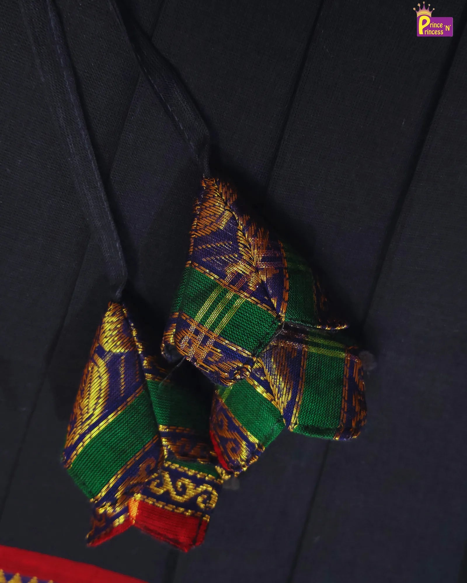 Colorful embroidered fabric on a dark background