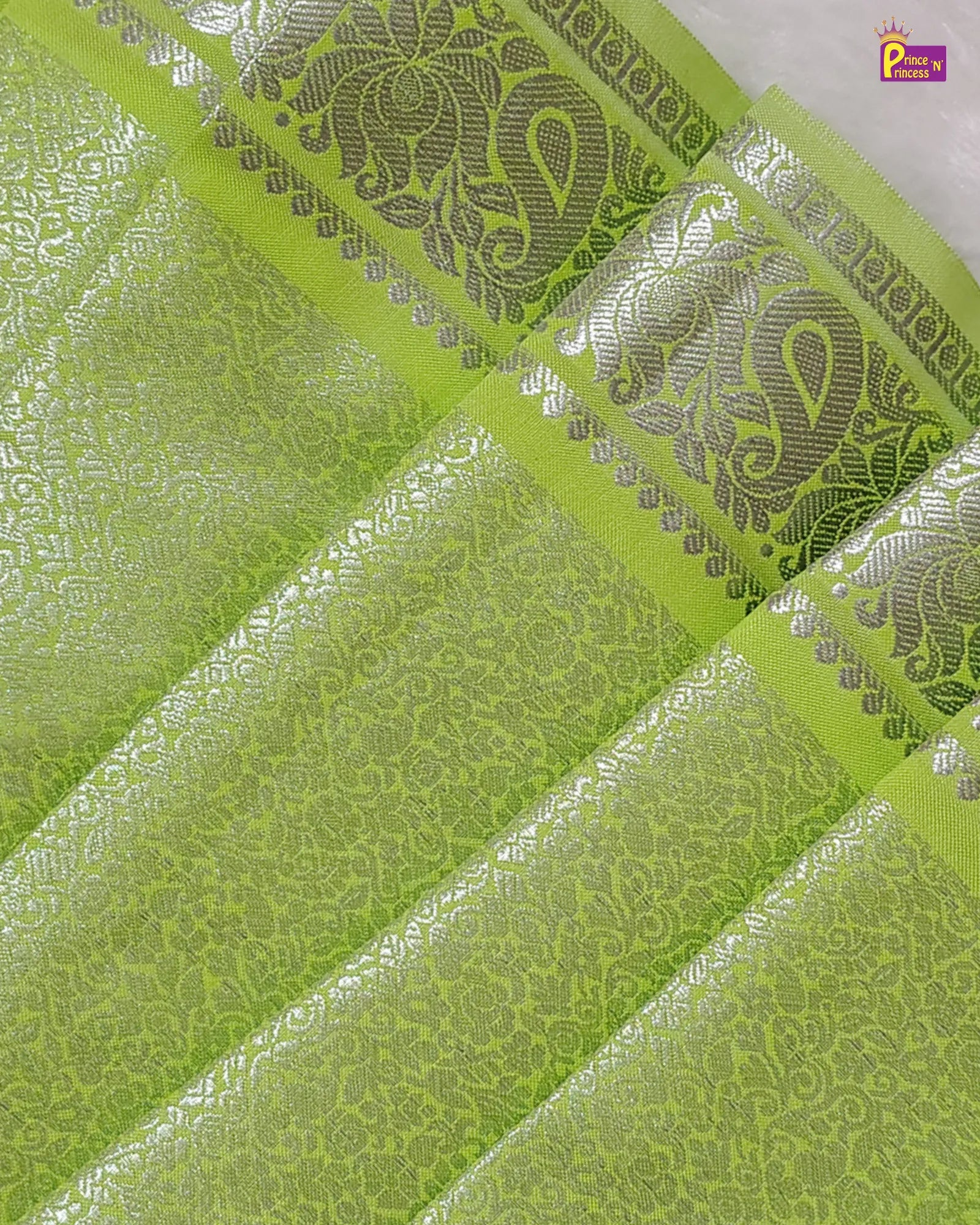 Green fabric with silver embroidery patterns