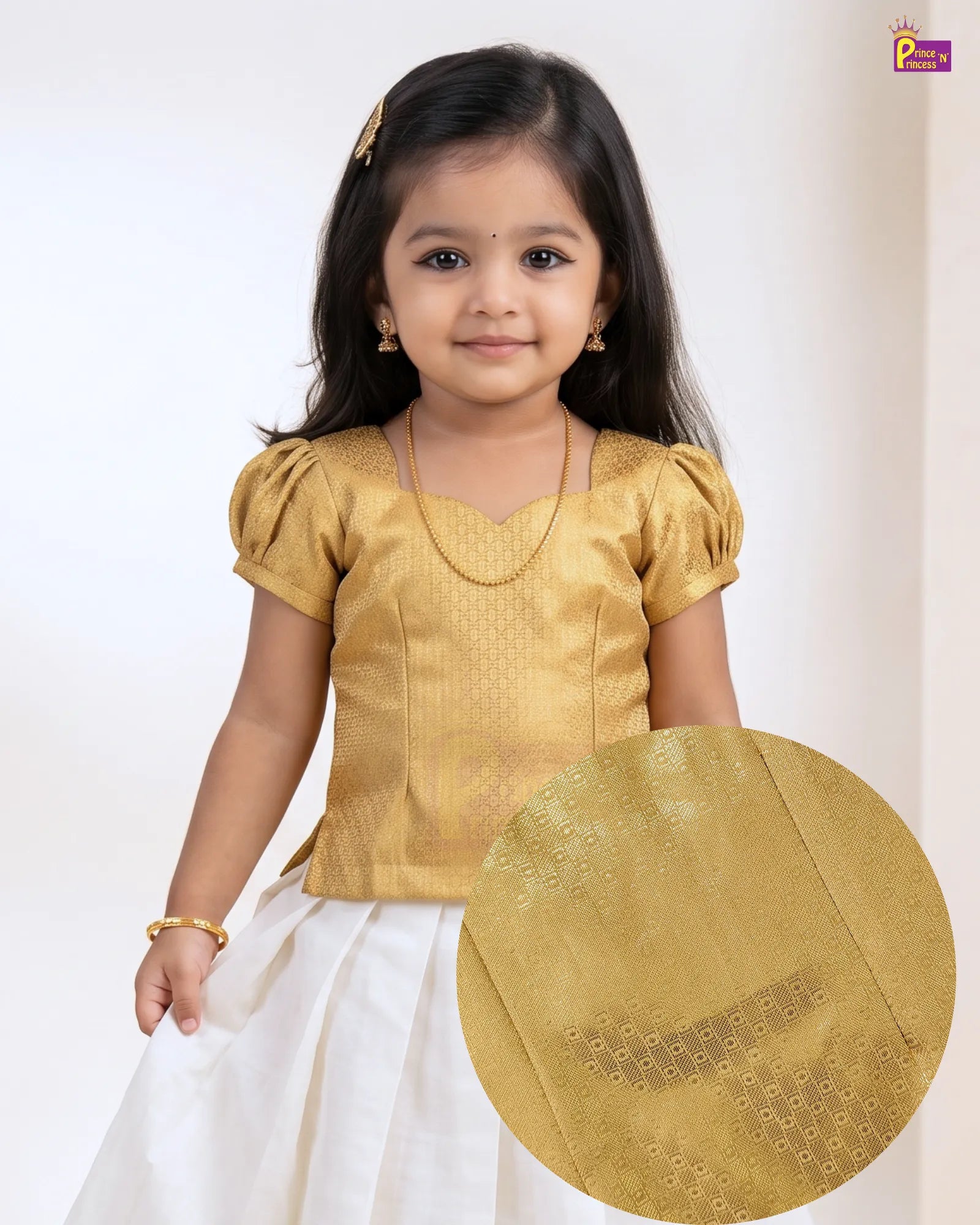 A young girl wearing a traditional Indian outfit with a textured gold blouse and a white skirt, shown against a plain light background with a circular fabric detail inset.